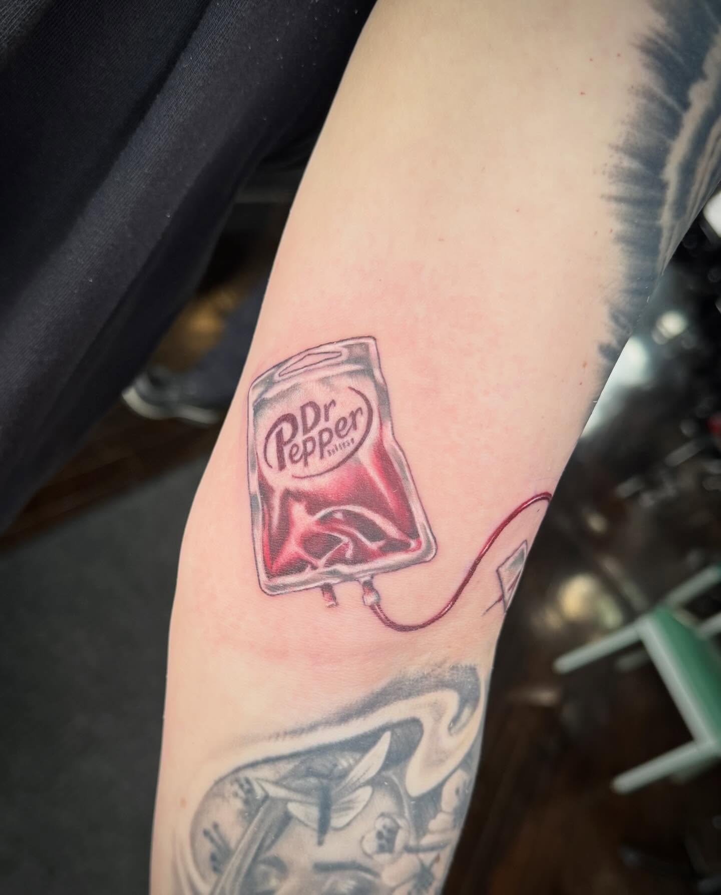Dr Pepper bag realism tattoo on the forearm by Paul Hicks
