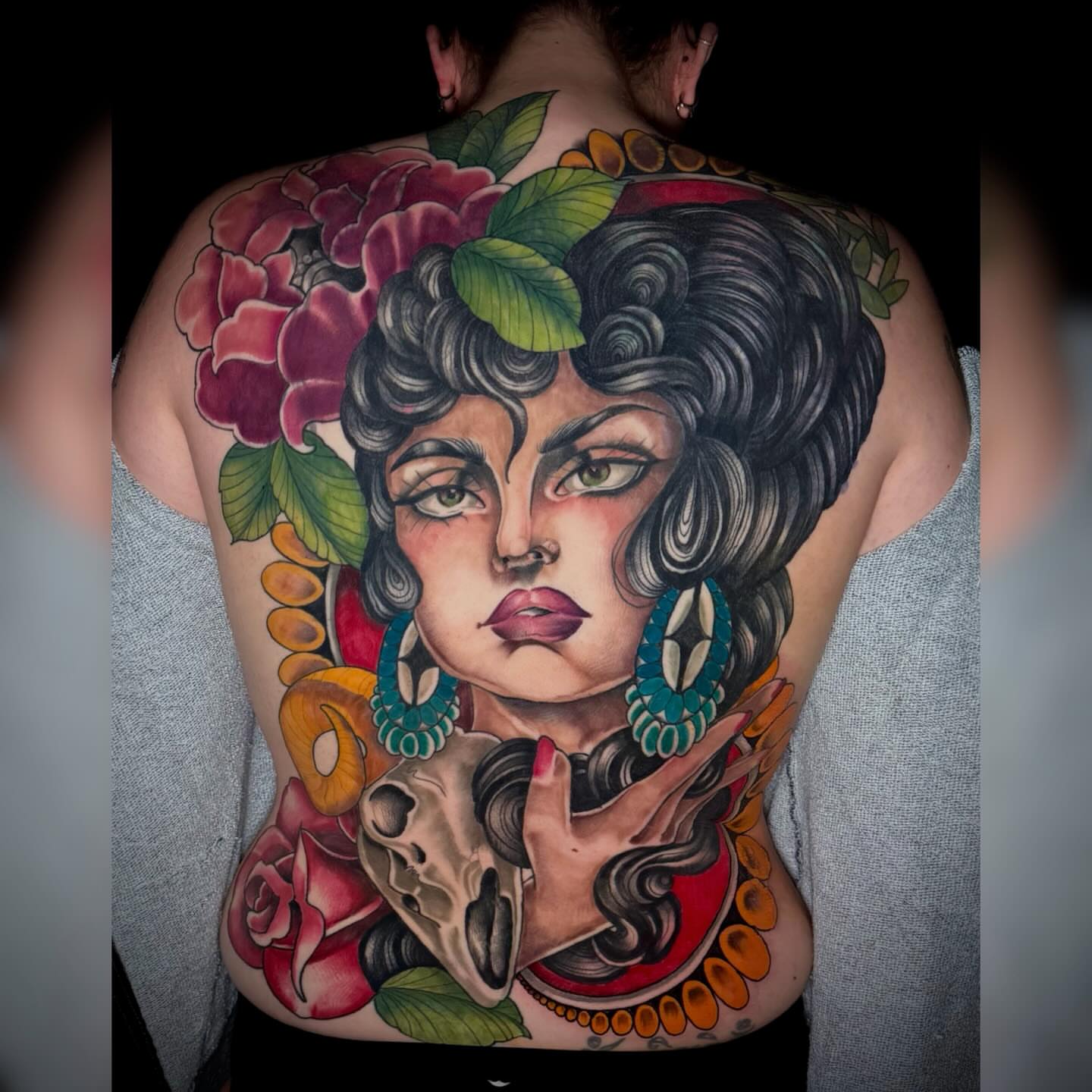 Woman with skull American traditional tattoo on the back by Alyssa Deeghan