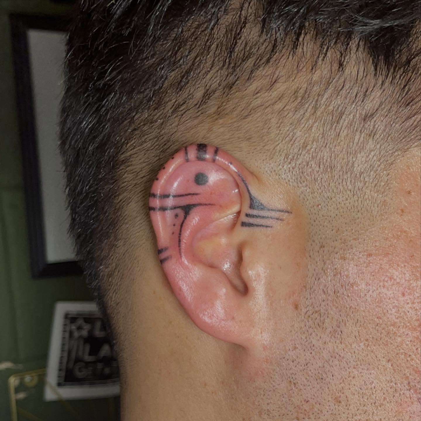 Ear geometric tattoo on the head by Permanent Pokes