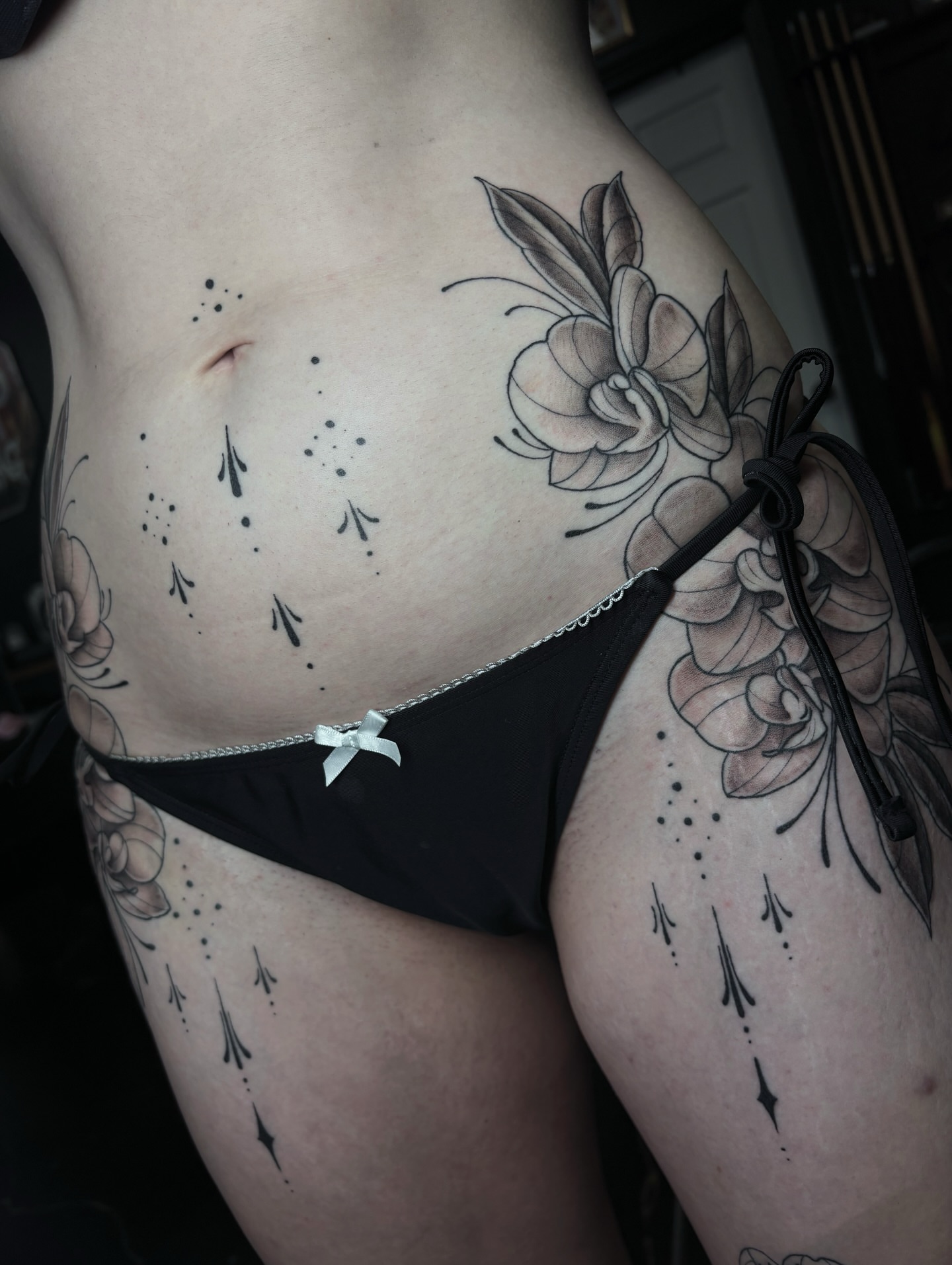 Floral dotwork tattoo on the torso by Fine Line Tattoo Artist