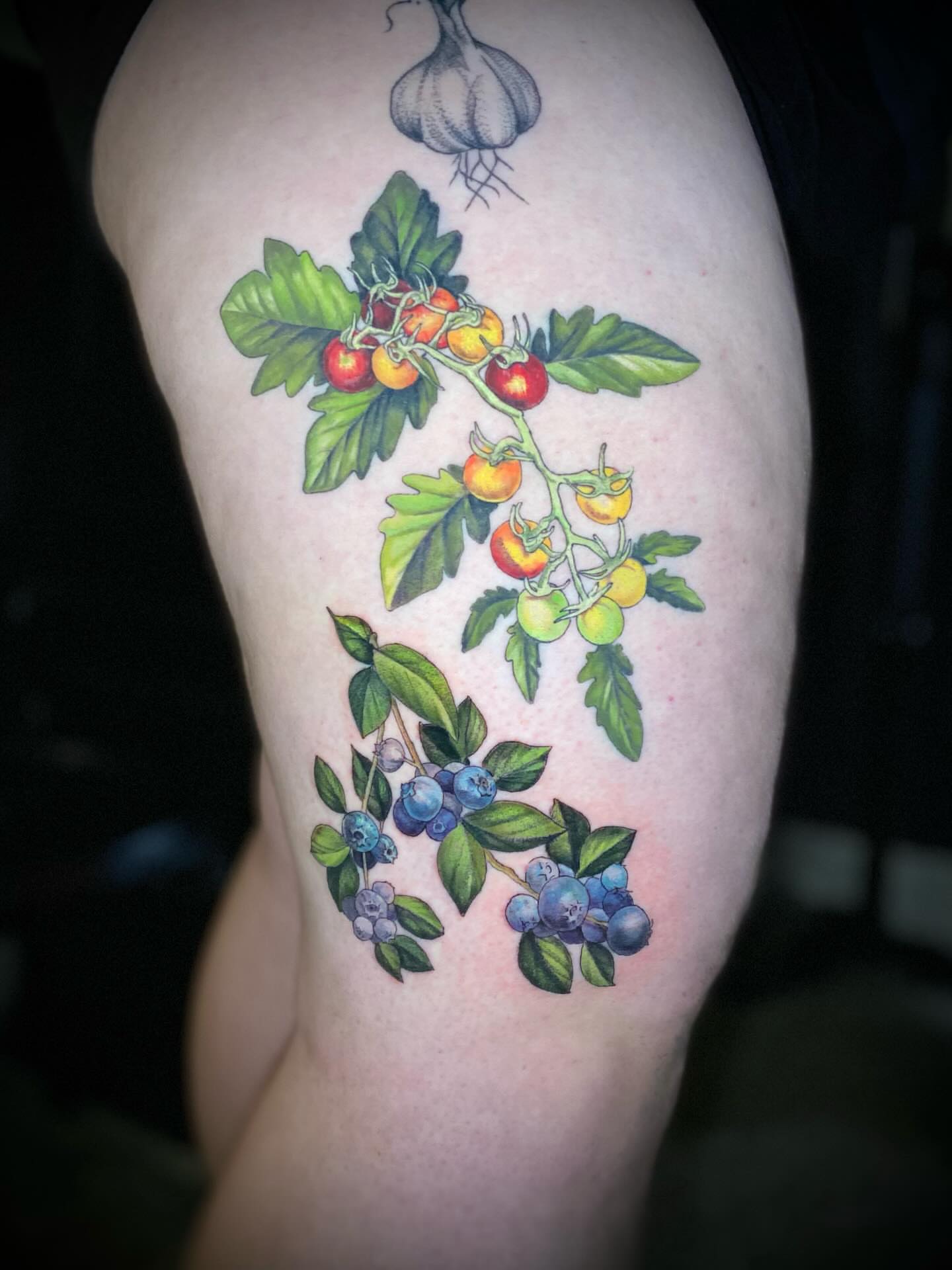 Tomatoes and blueberries realism tattoo on the thigh by Olivia Scott - Kansas Tattoo Artist