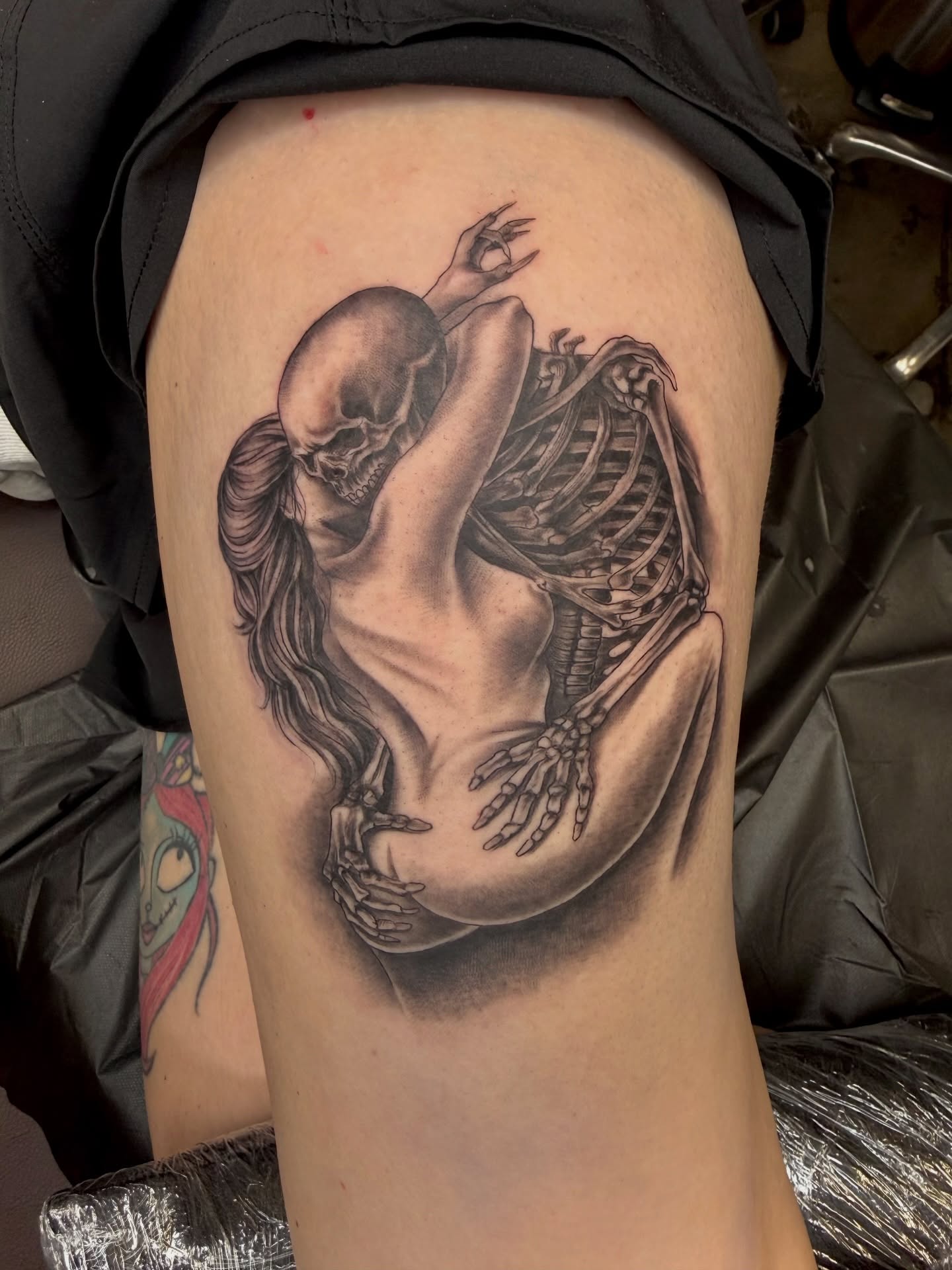 Woman and skeleton realism tattoo on the thigh by Ricky Sanchez, Duncanville, Texas