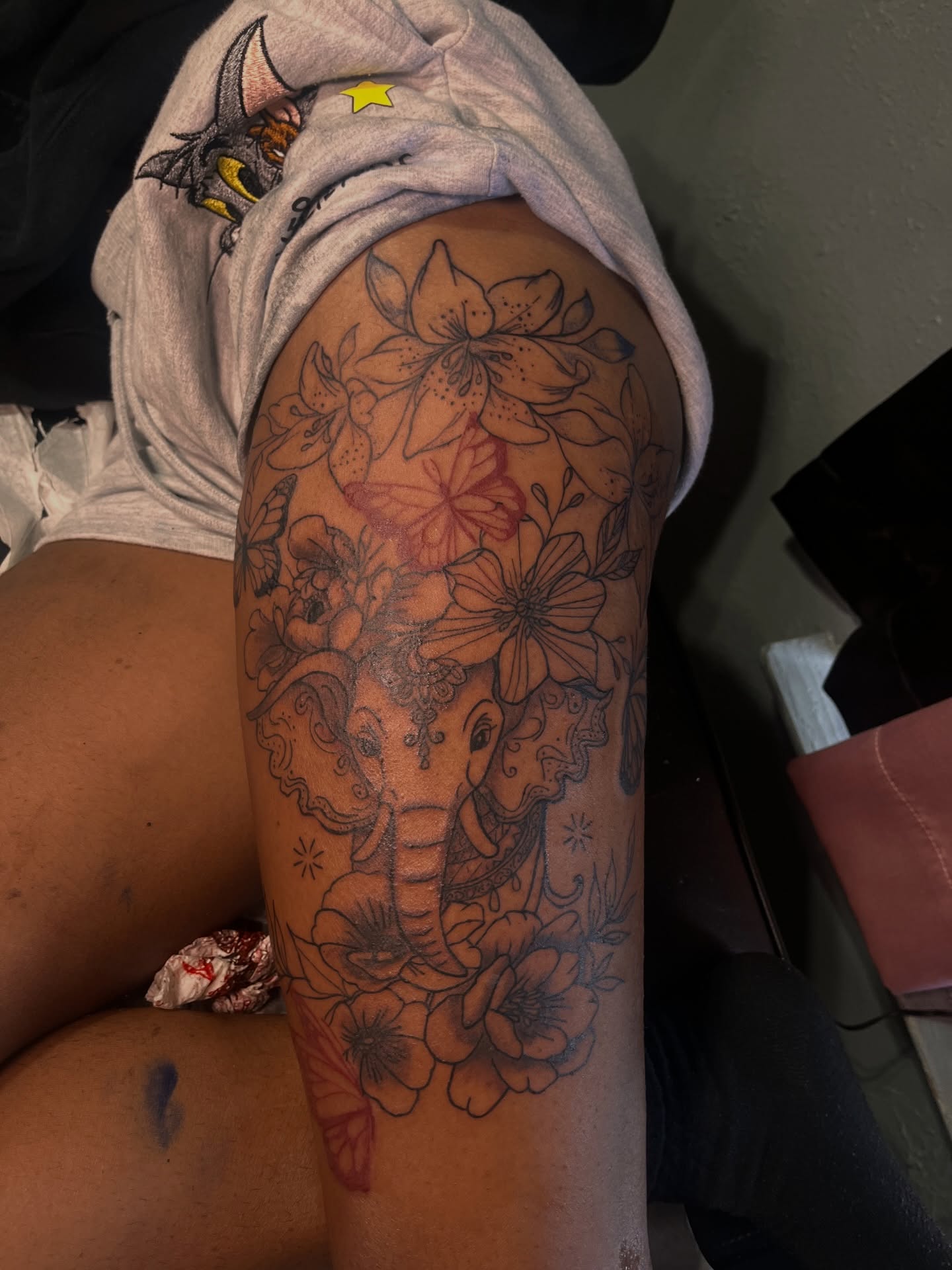 Elephant and floral black and grey tattoo on the thigh by The inspo