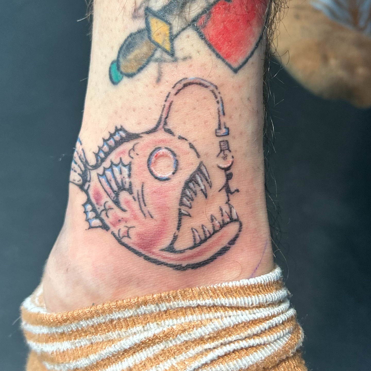 Angler fish American traditional tattoo on the forearm by Natalie Johnson, Minneapolis, Minnesota