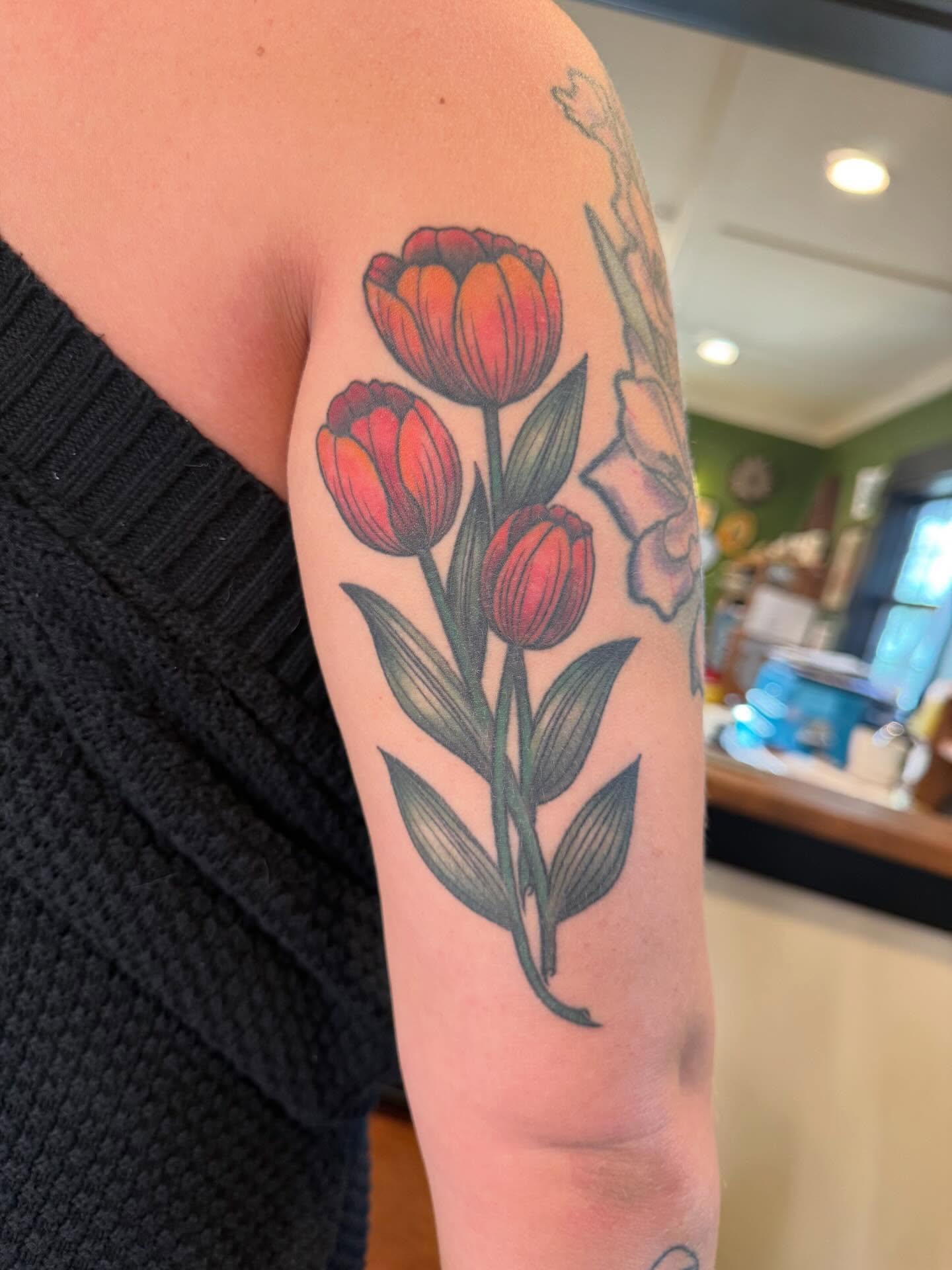 Tulips realism tattoo on the forearm by Rebecca Basma Smith