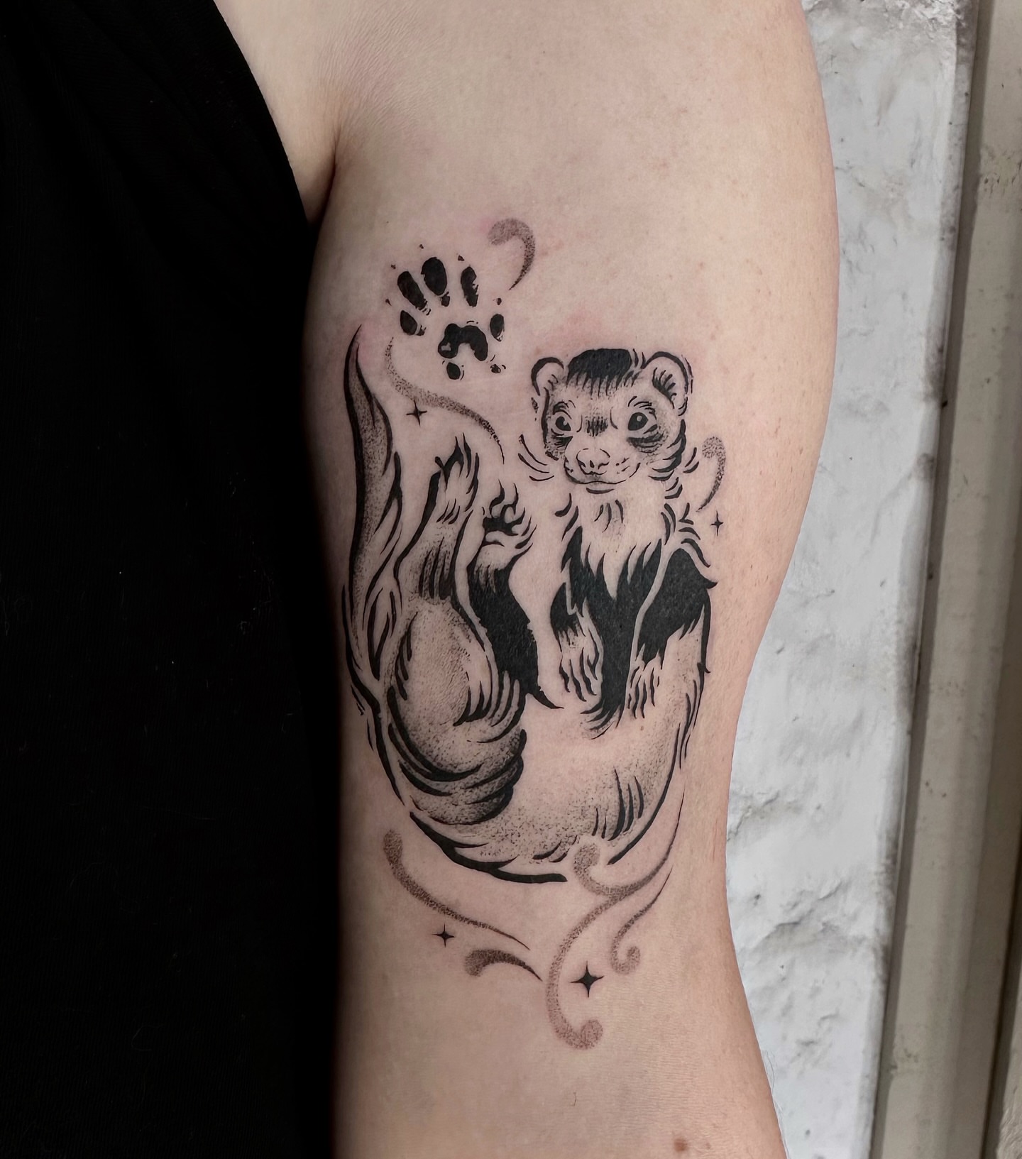 Ferret and paw print dotwork tattoo on the forearm by Micky, Austin, Texas