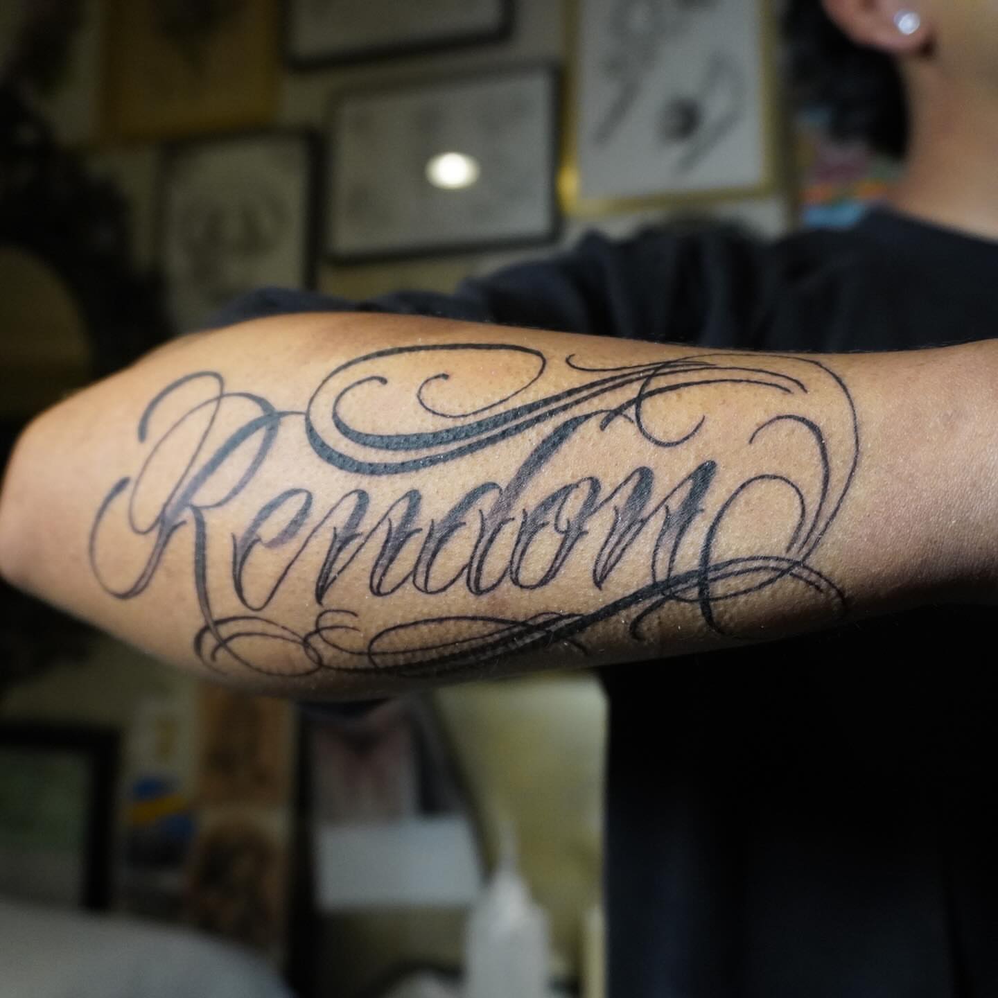 Random lettering script tattoo on the forearm by San Diego tattoo artist