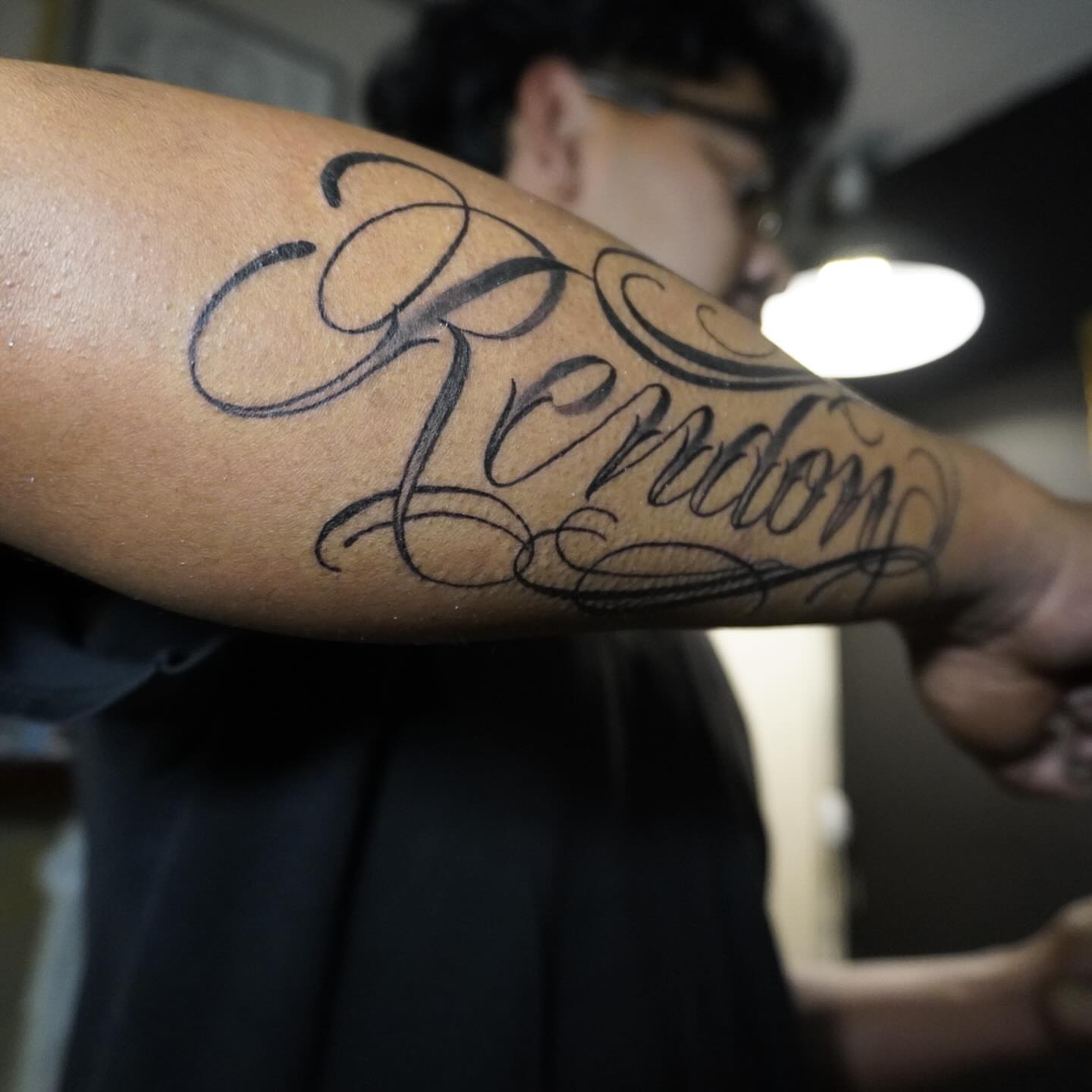 Script lettering lettering script tattoo on the forearm by San Diego tattoo artist