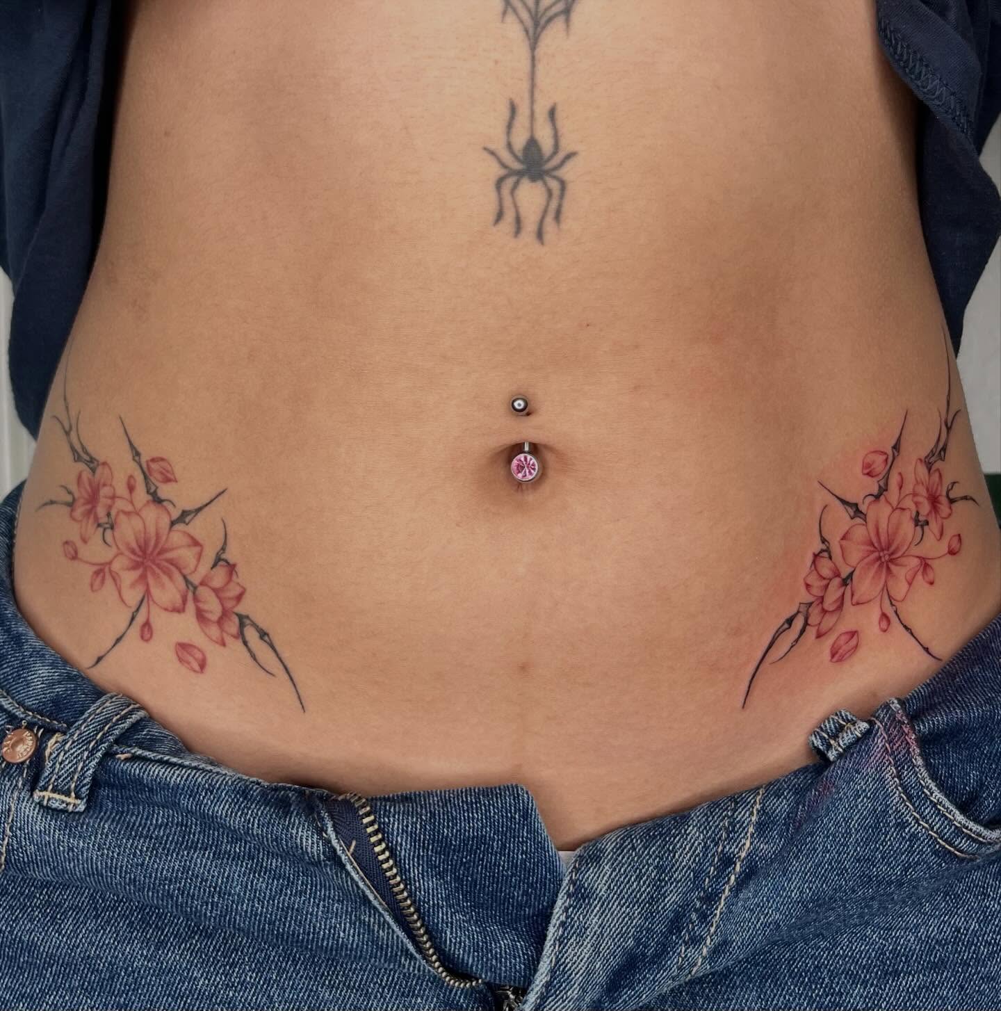 Cherry blossoms dotwork tattoo on the torso by Ash F