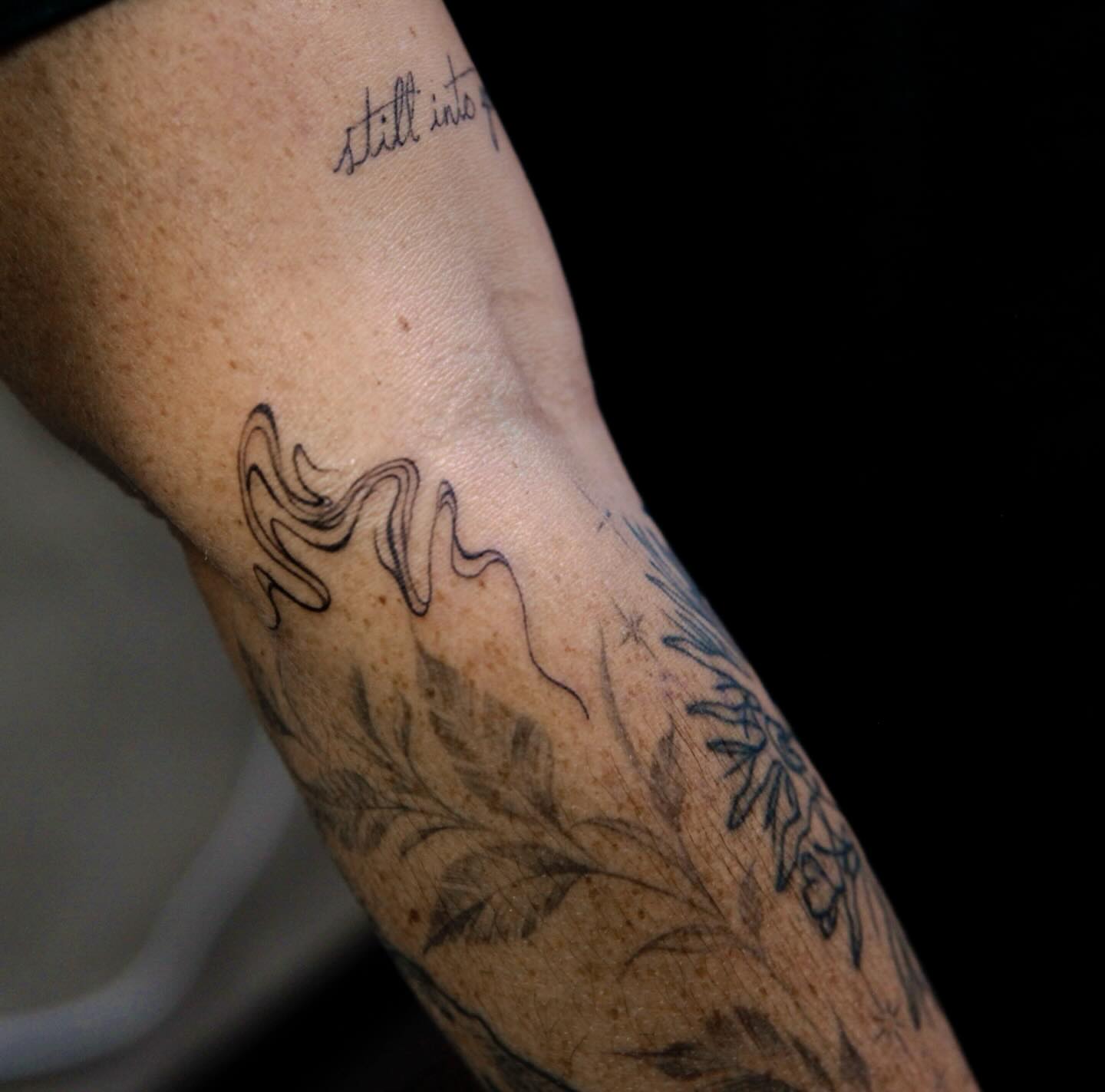 Floral design black and grey tattoo on the forearm by Liv