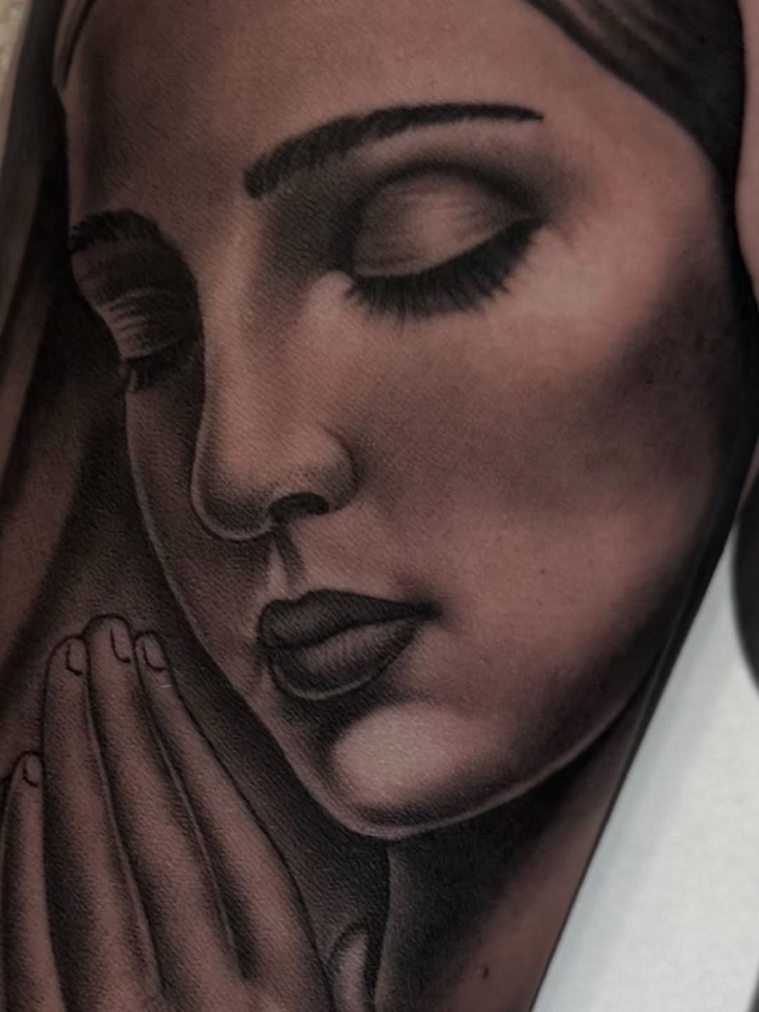 Woman praying Chicano tattoo on the forearm by Hugo Ruiz-Esparza
