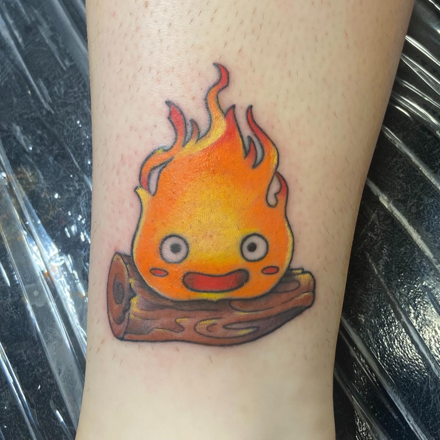 Flaming character dotwork tattoo on the forearm by Sam Hearnen, Lawrence, Kansas