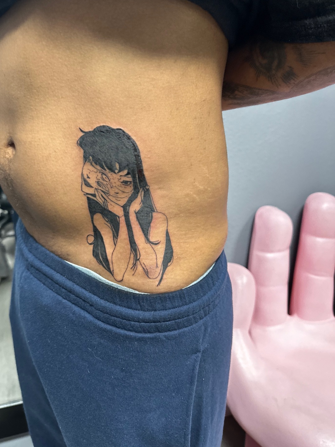 Anime character tattoo on the ribs by Lupita Ink
