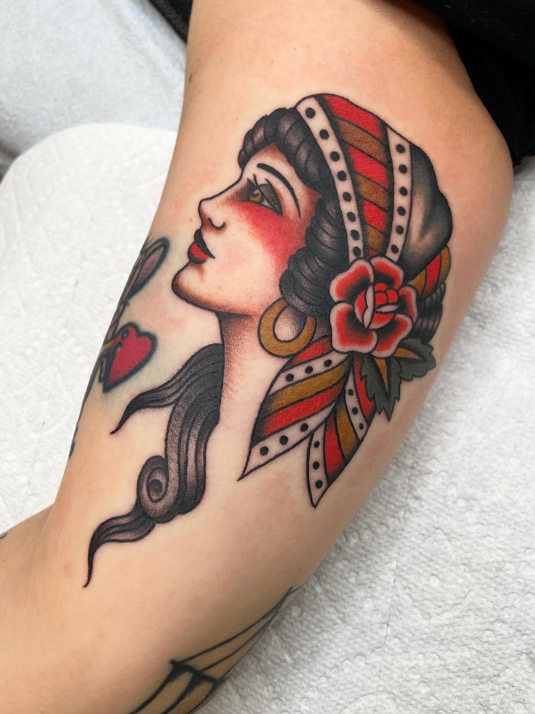 Woman with bandana and rose neo-traditional tattoo on the thigh by Kat, Sacramento, California