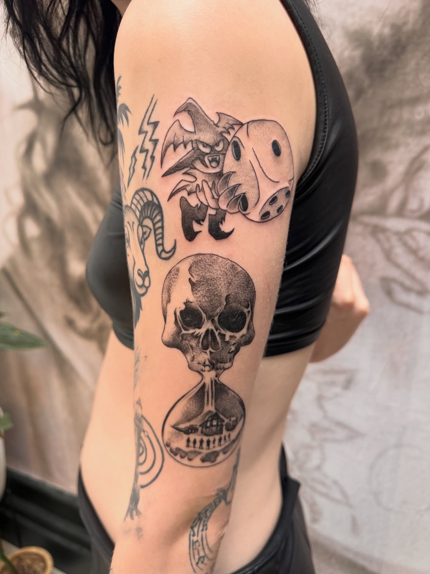 Hourglass with skull dotwork tattoo on the forearm by Sam Padilla
