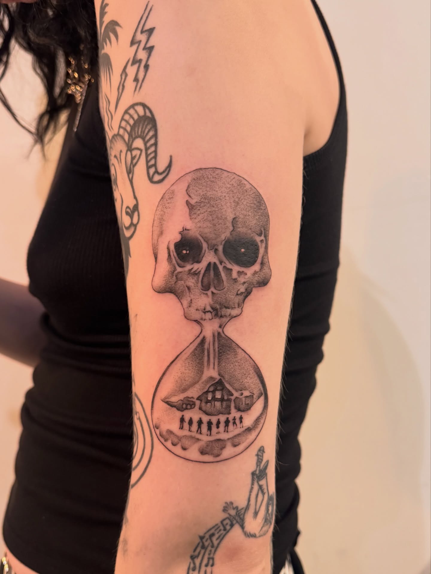 Hourglass with skull dotwork tattoo on the forearm by Sam Padilla