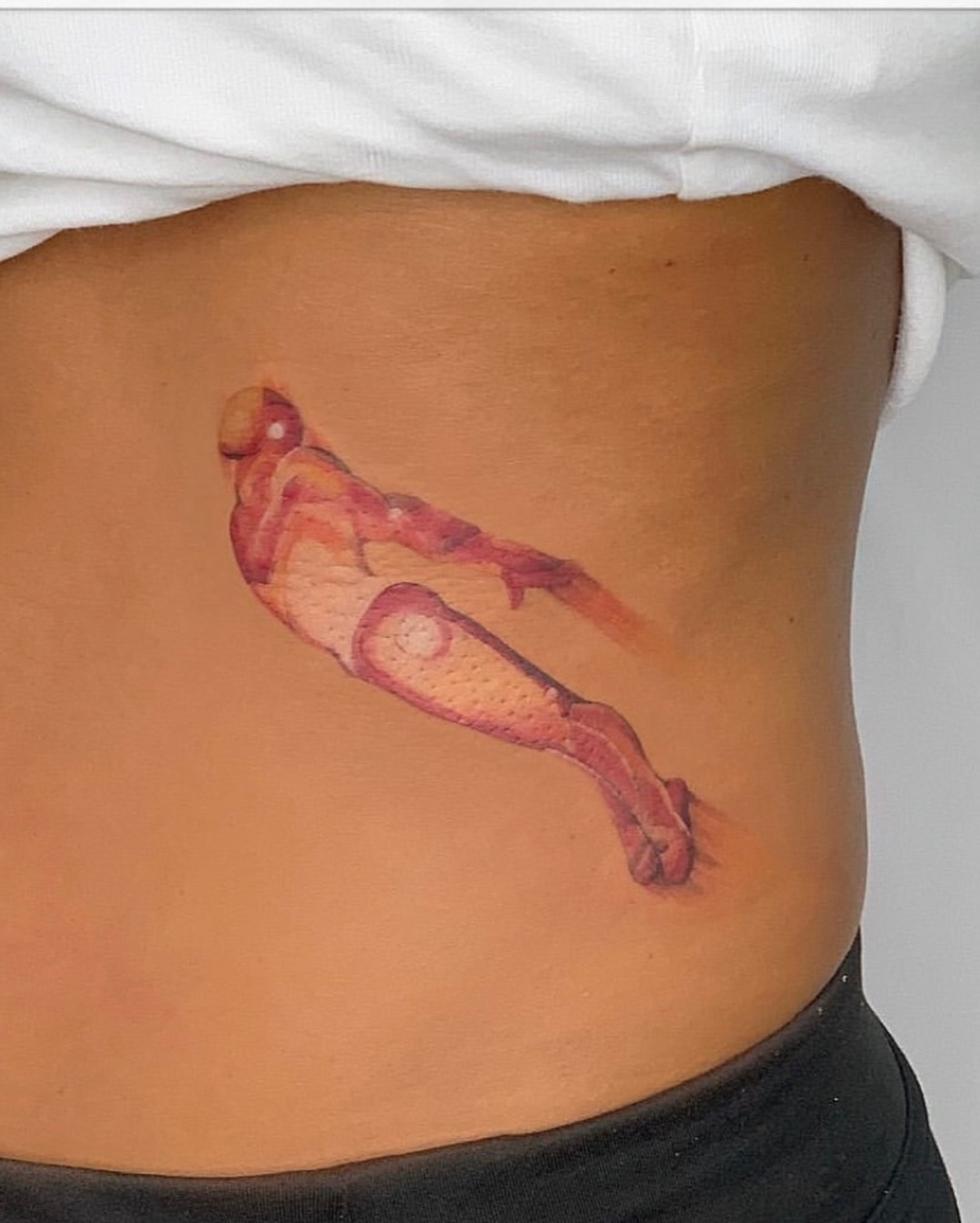 Man in dynamic pose realism tattoo on the torso by NAS