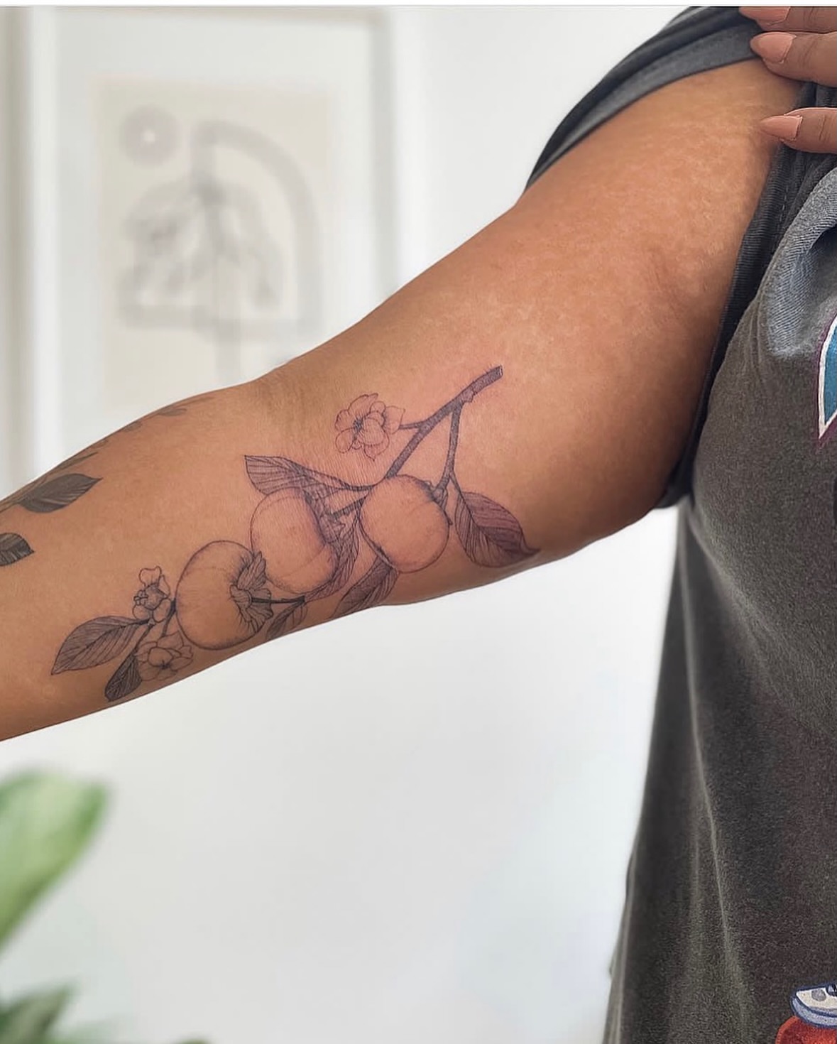 Branch with fruit black and grey tattoo on the forearm by NAS