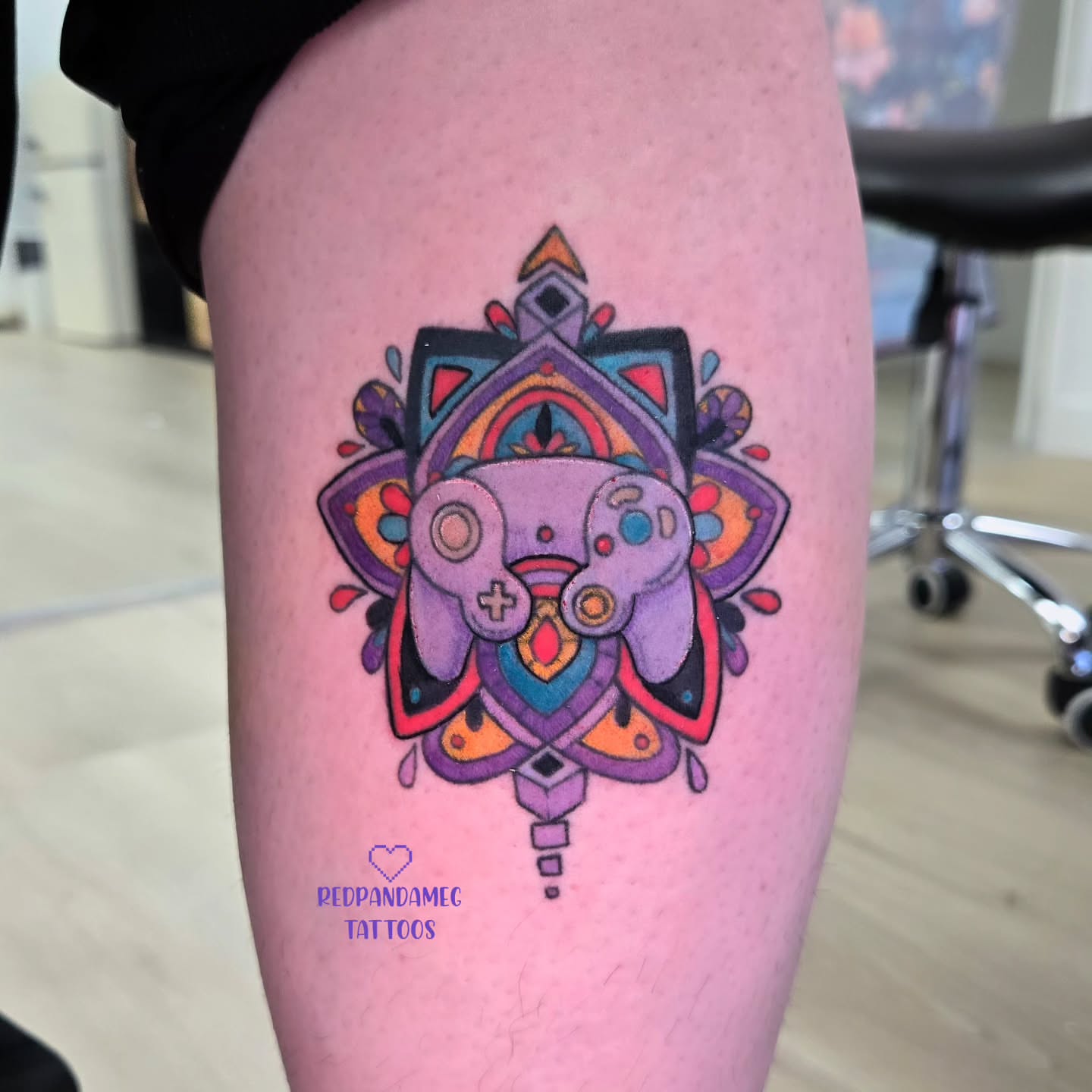 Video game controller geometric tattoo on the thigh by Meghan Hounsell