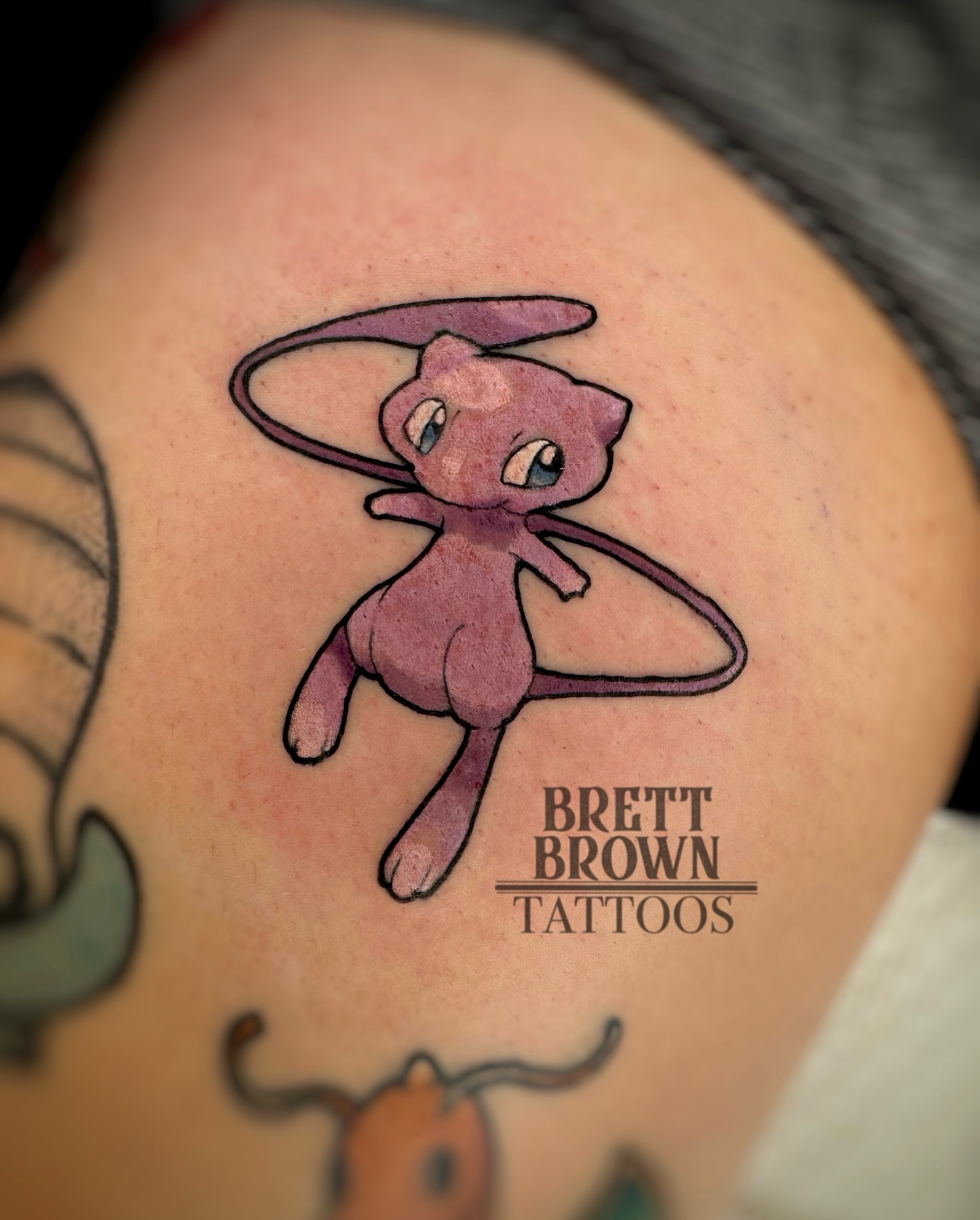 Mew dotwork tattoo on the shoulder by Brett Brown