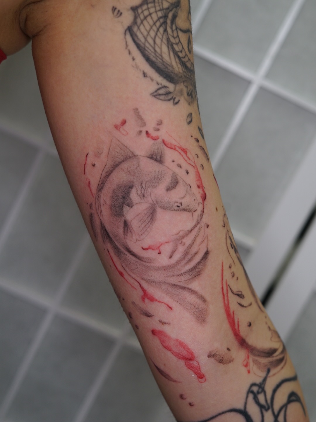 Fish dotwork tattoo on the forearm by Josh Infante