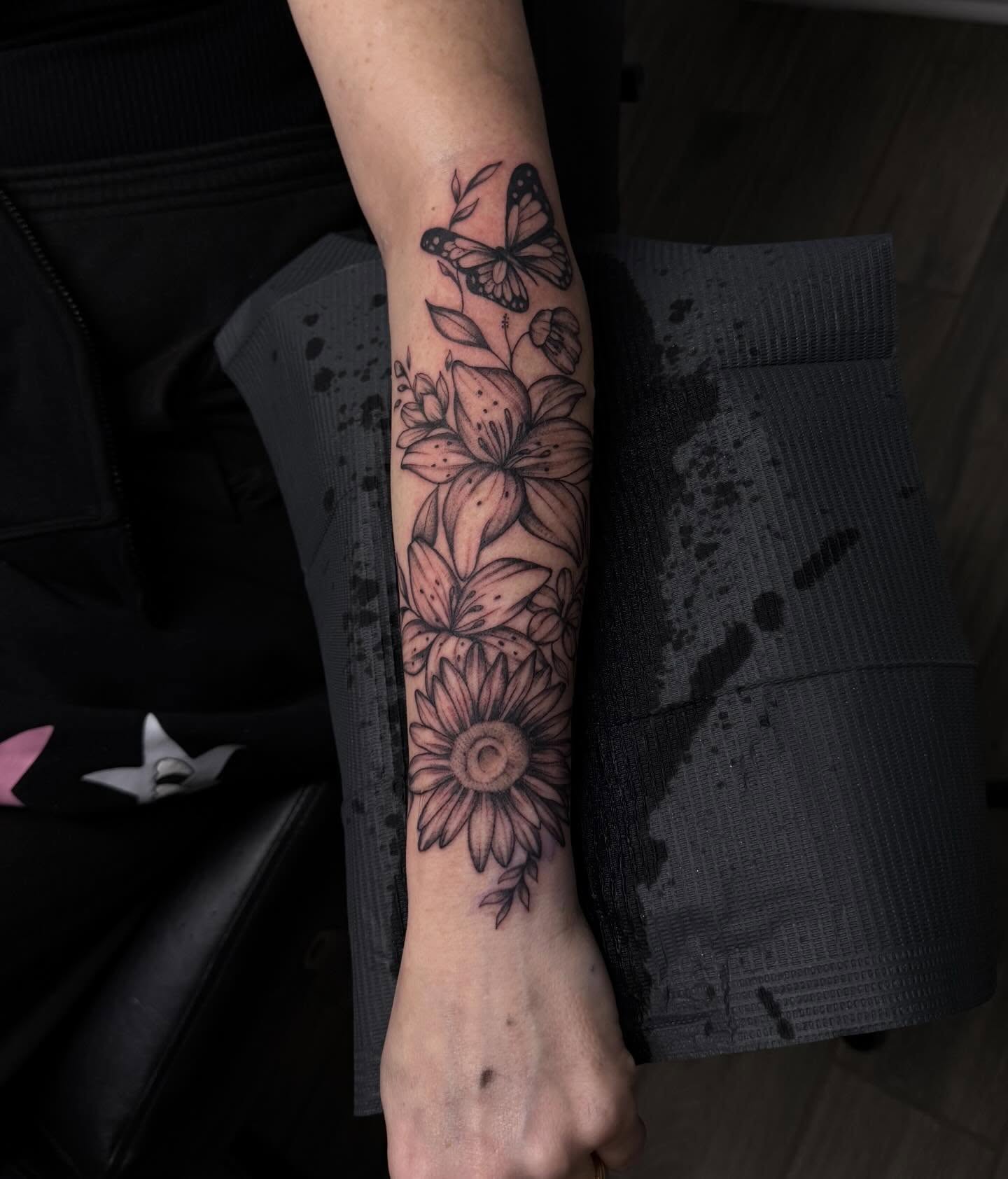 Flowers and butterfly black and grey tattoo on the forearm by Stephania ATLANTA TATTOO ARTIST🎨
