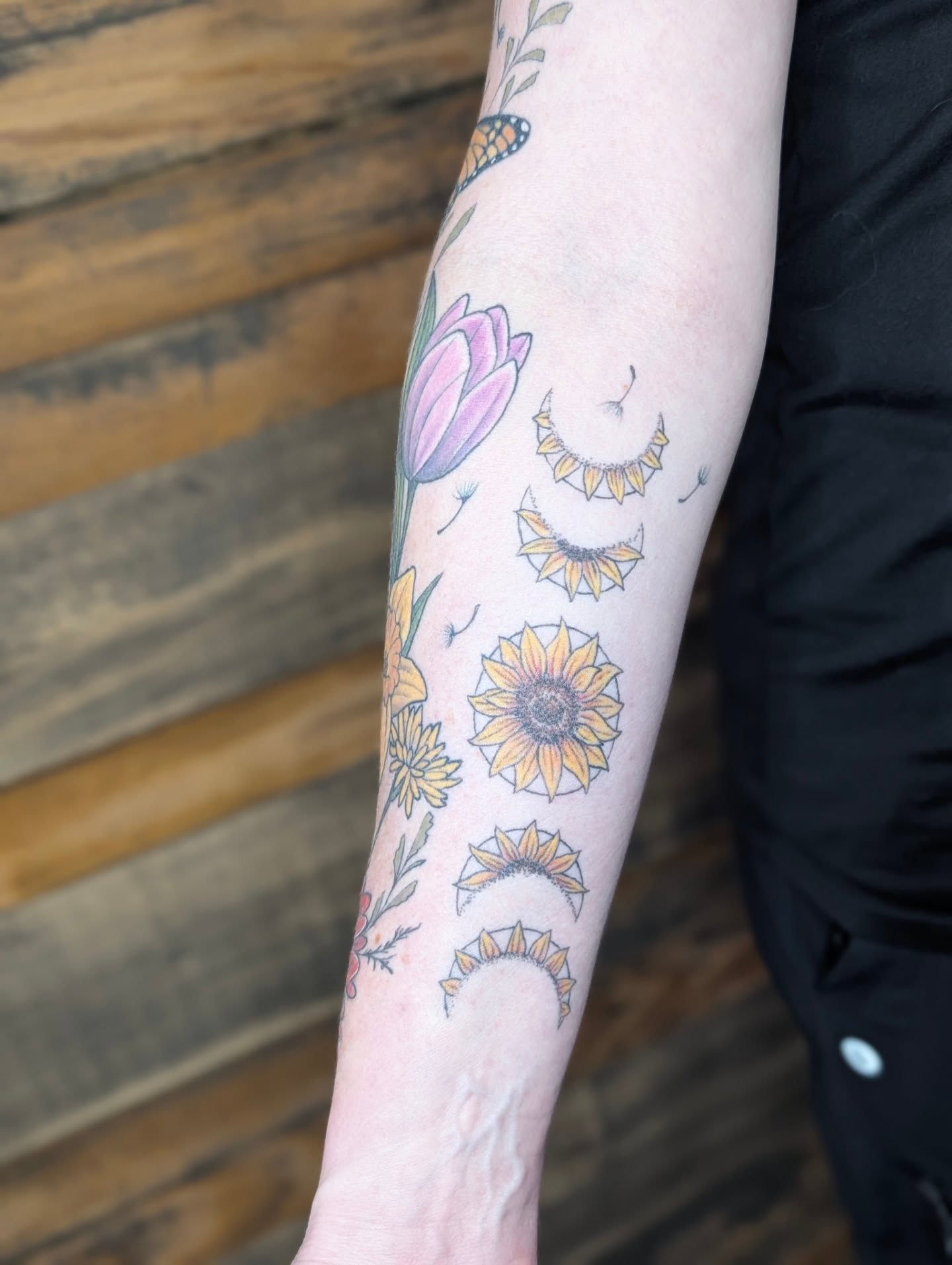 Sunflowers and tulips new school tattoo on the forearm by SHOP53 Tattoo & Art