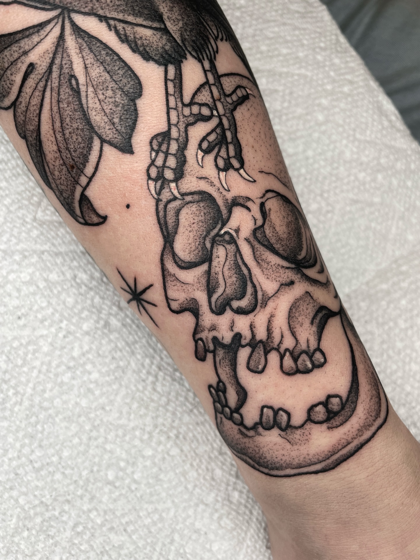 Skull dotwork tattoo on the forearm by Emily Lux