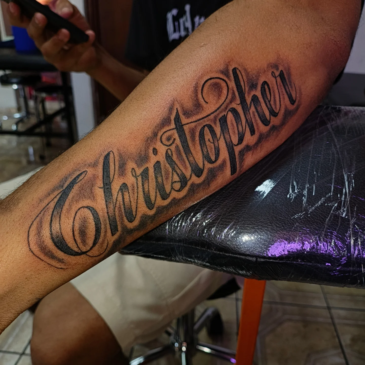 Christopher lettering script tattoo on the forearm by Alexander Tattooink