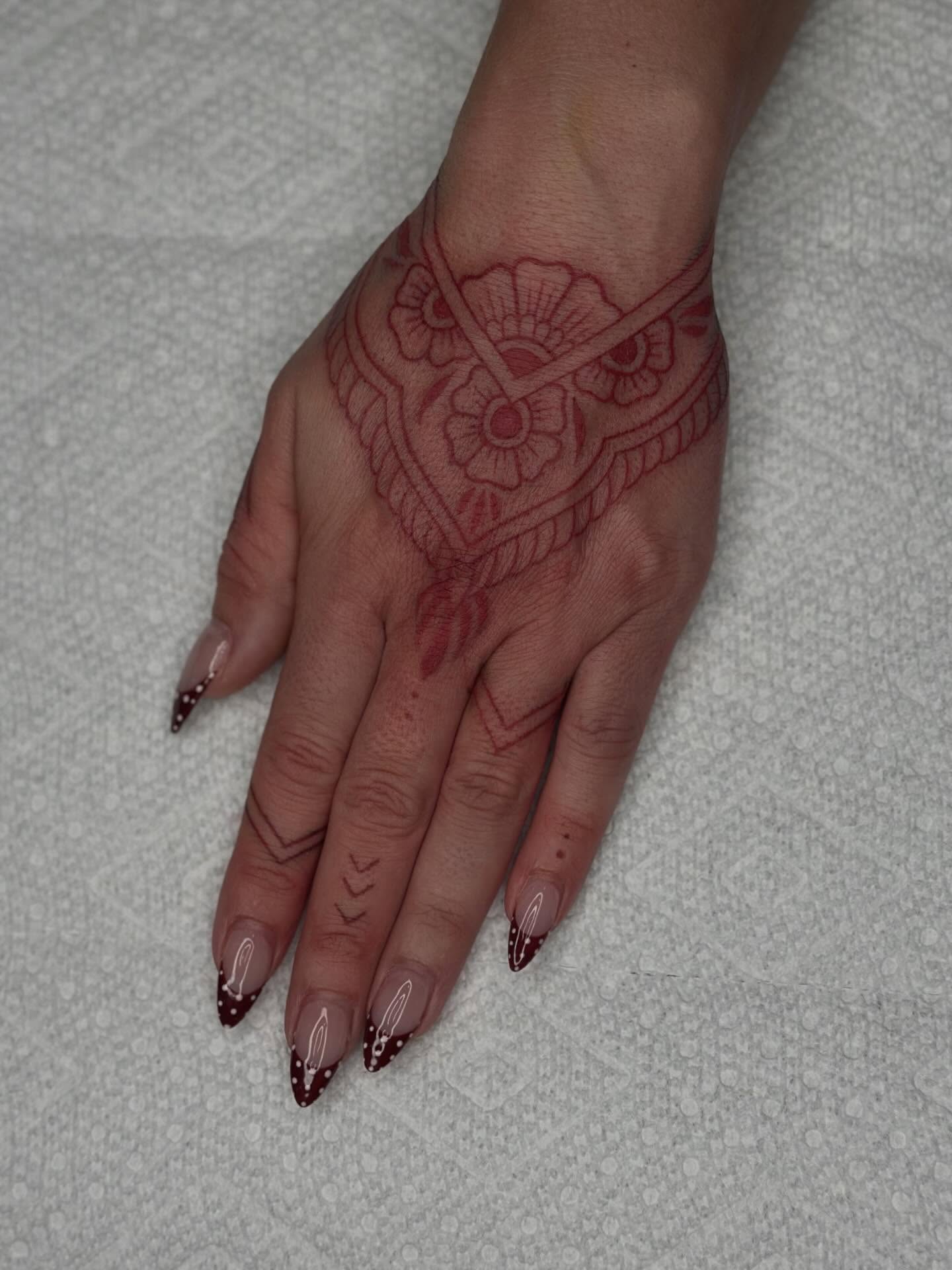 Floral design ornamental tattoo on the hand by Kat Fishbein