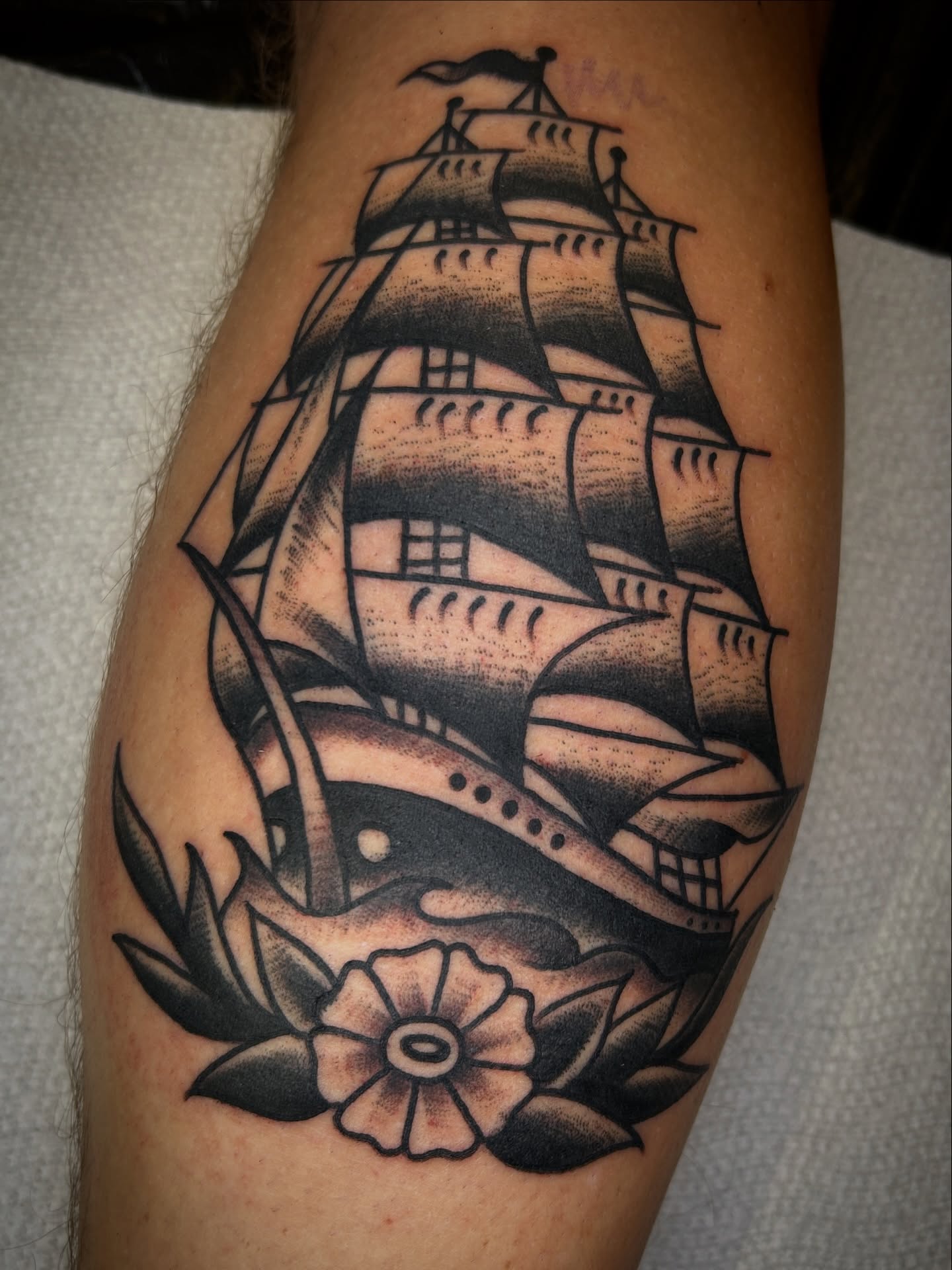 Ship and flower American traditional tattoo on the forearm by Eric Caudill, Indianapolis, Indiana