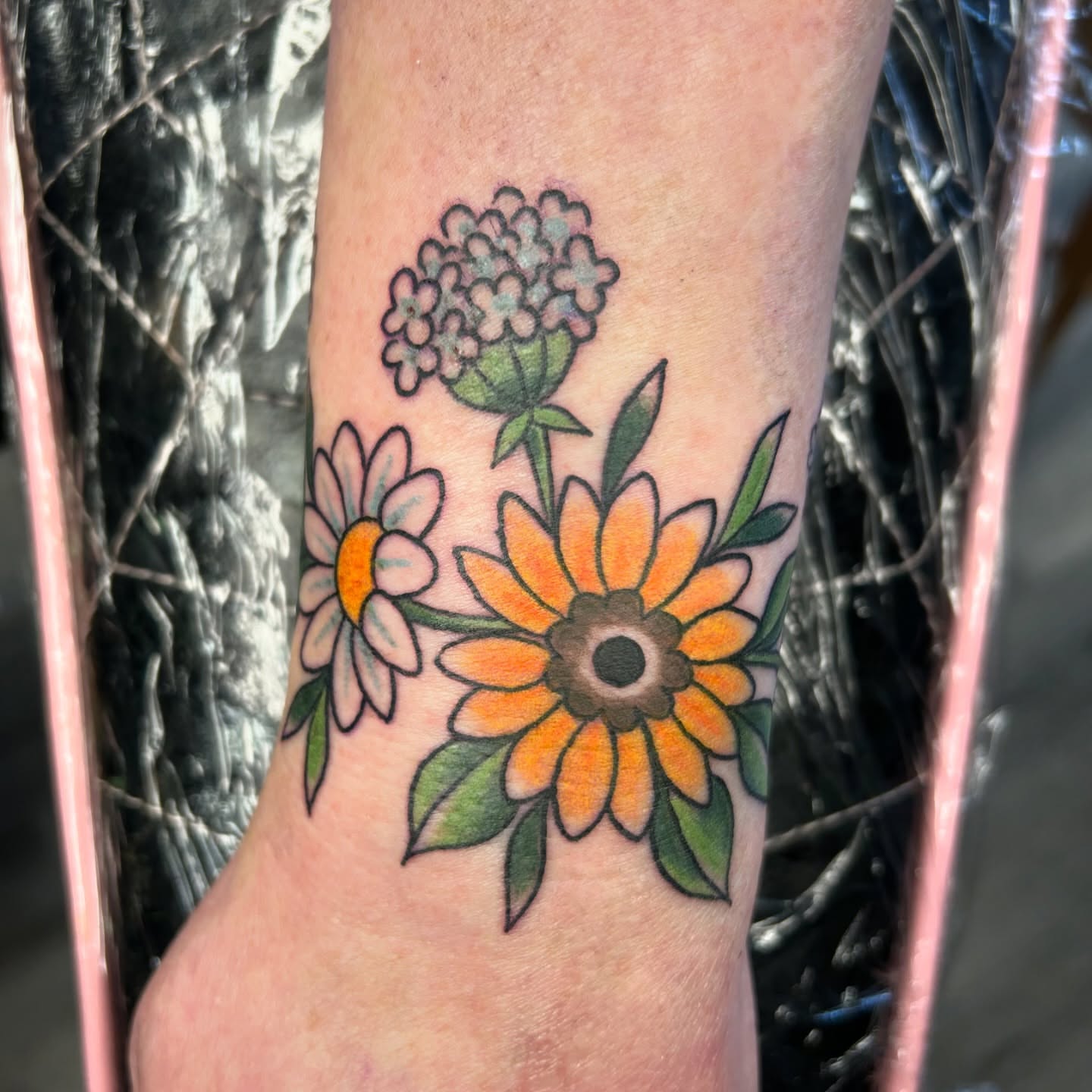 Sunflowers American traditional tattoo on the forearm by Audrey Migitsch