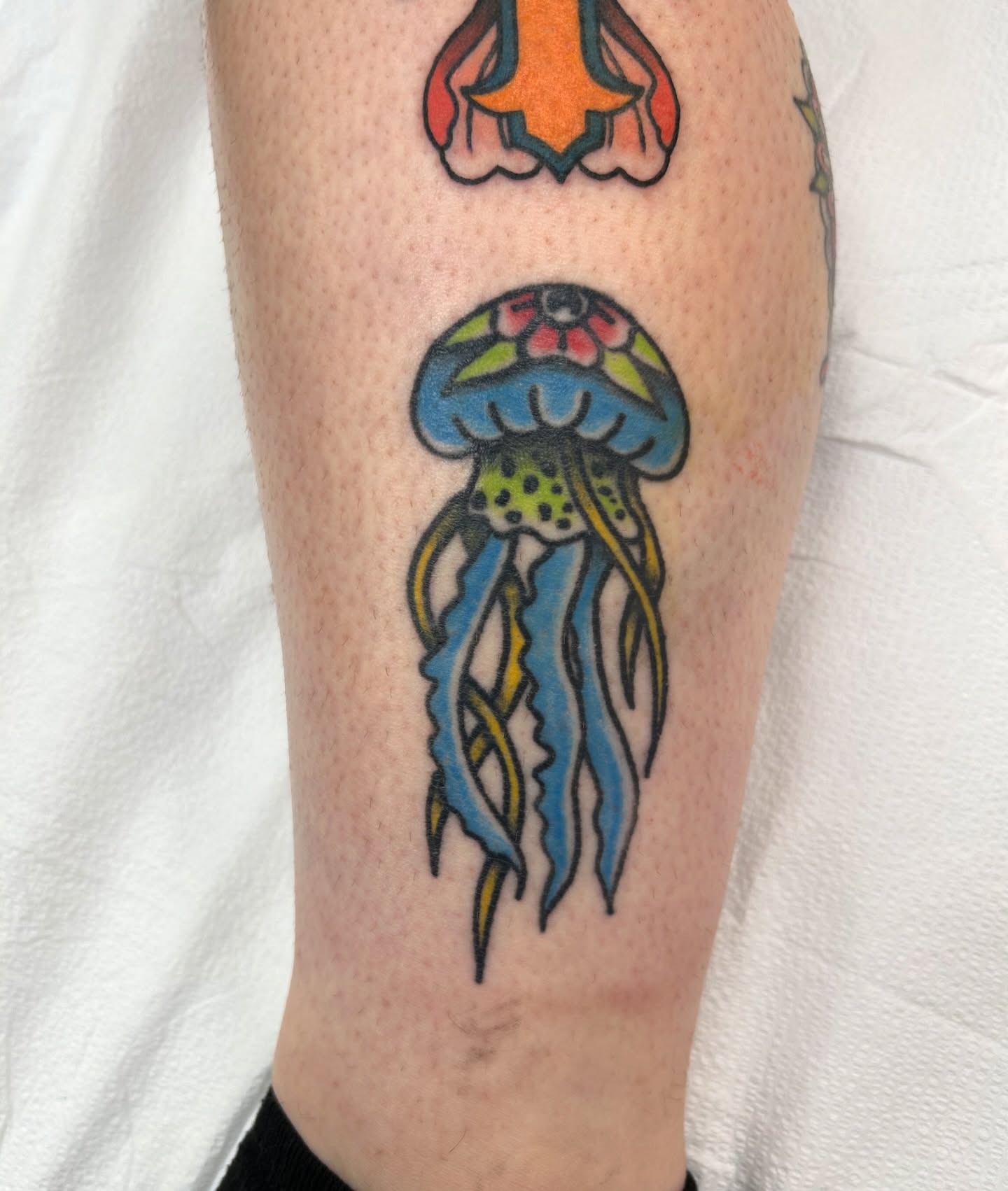 Jellyfish American traditional tattoo on the calf by Courtney