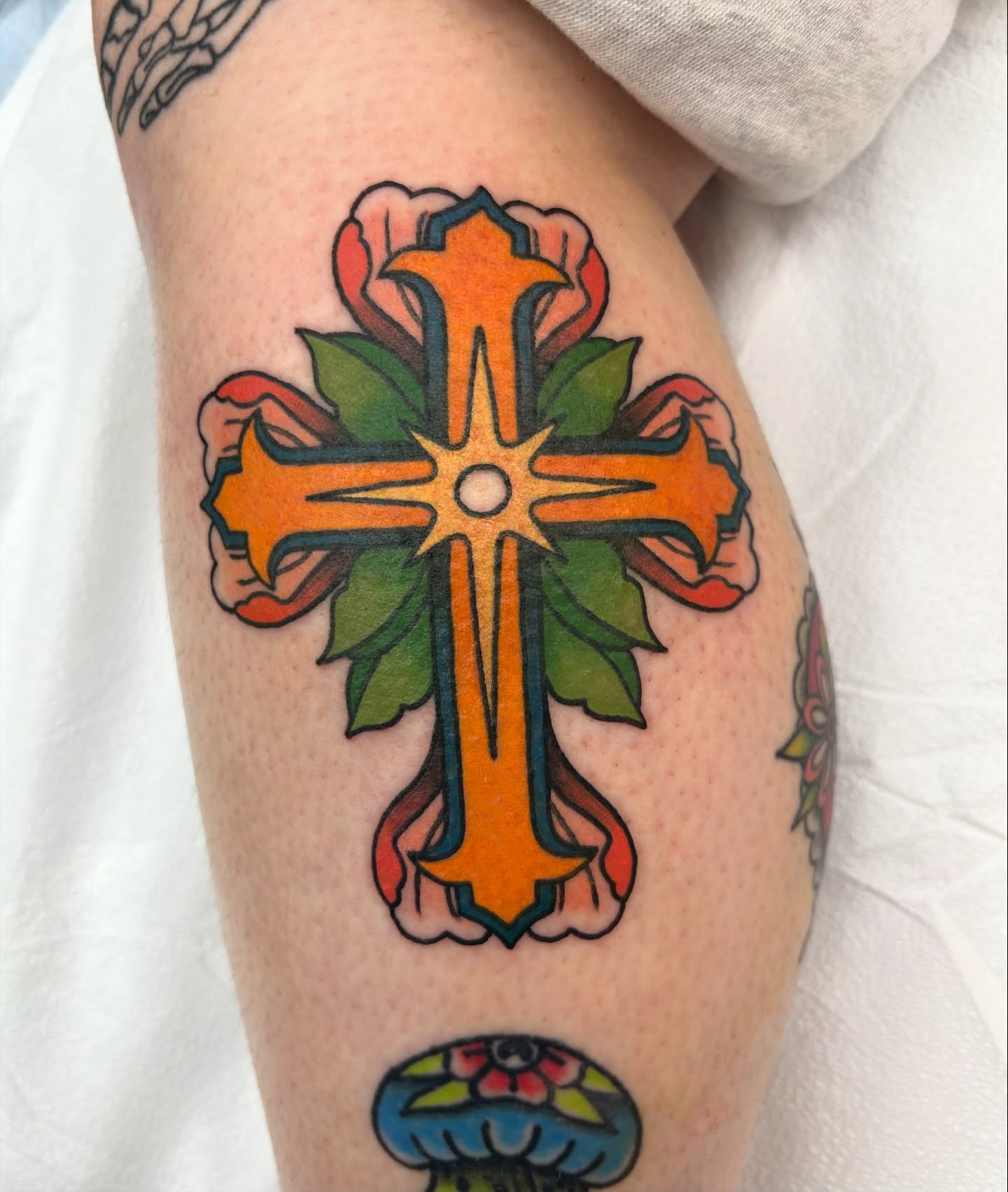 Cross American traditional tattoo on the forearm by Courtney