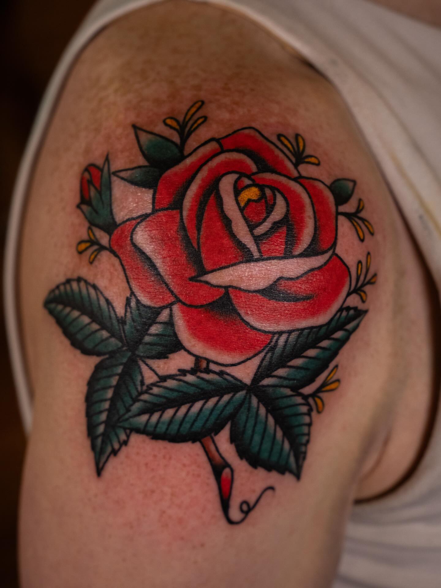 Red rose American traditional tattoo on the shoulder by Justin Rakowski