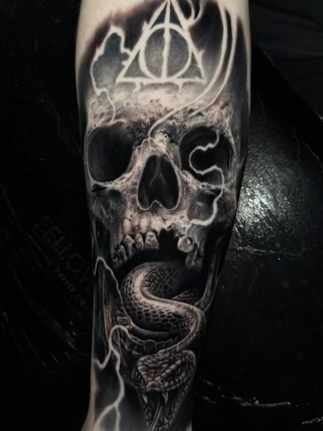 Skull, snake, and deathly hallows symbol dark art tattoo on the forearm by ππ―ππ³π¦π° πππͺπ¬π«π±