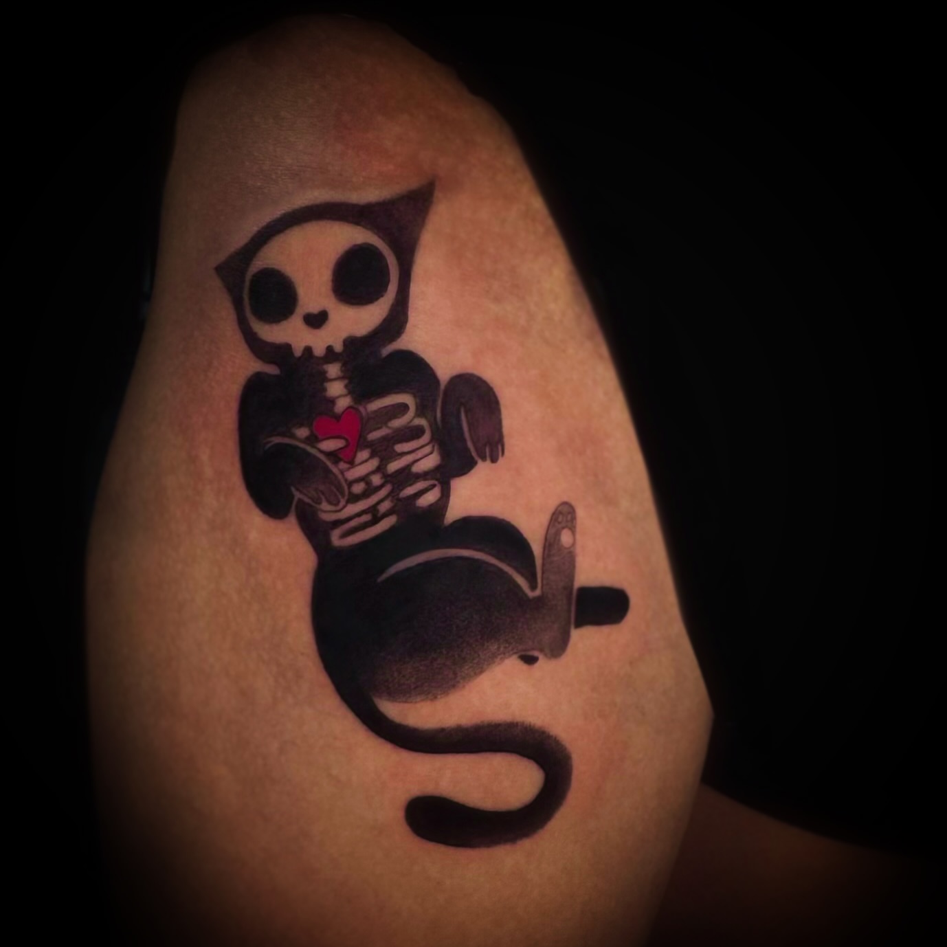 Skeleton cat black and grey tattoo on the upper arm by allison