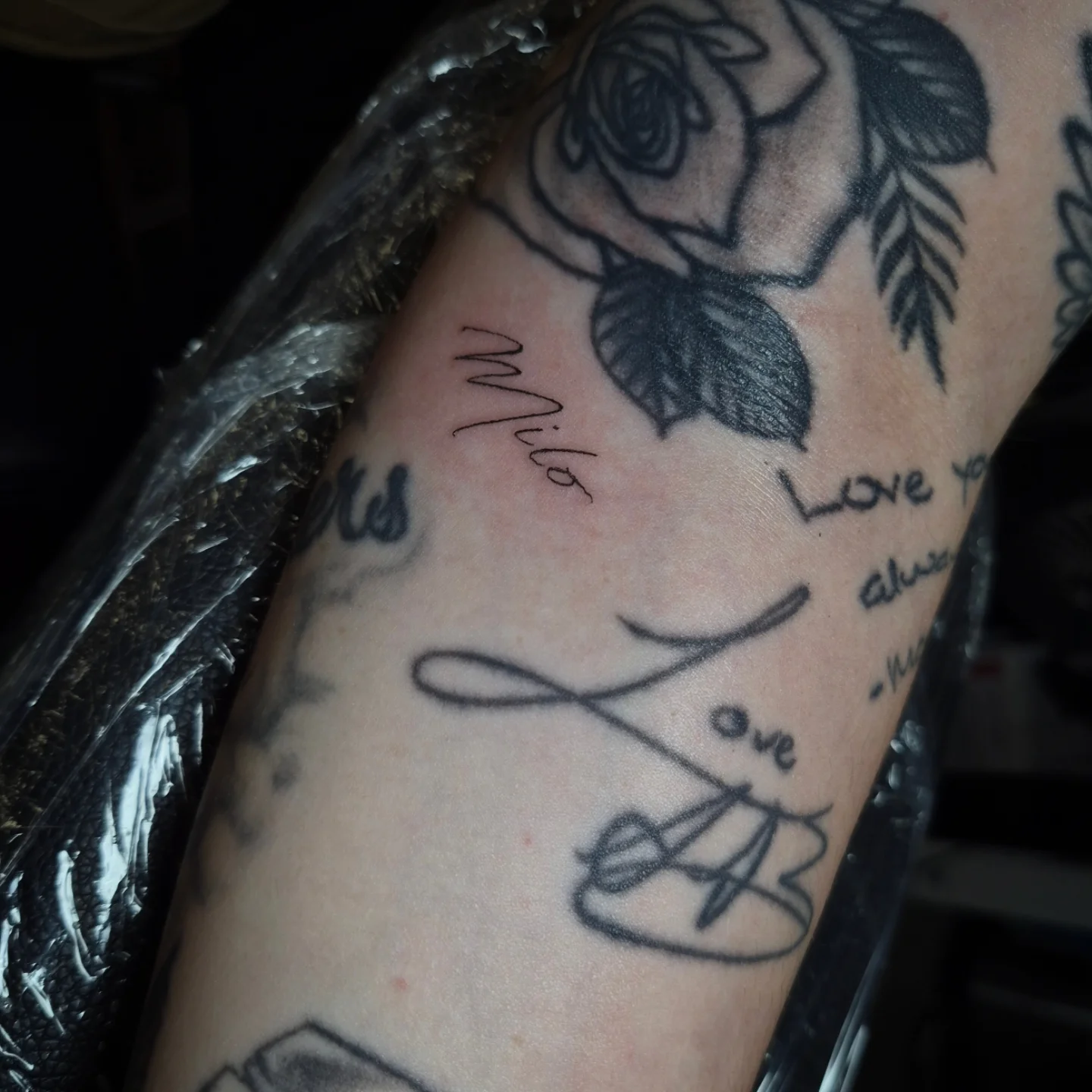 Rose and infinity symbol black and grey tattoo on the forearm by Lydia Kiley