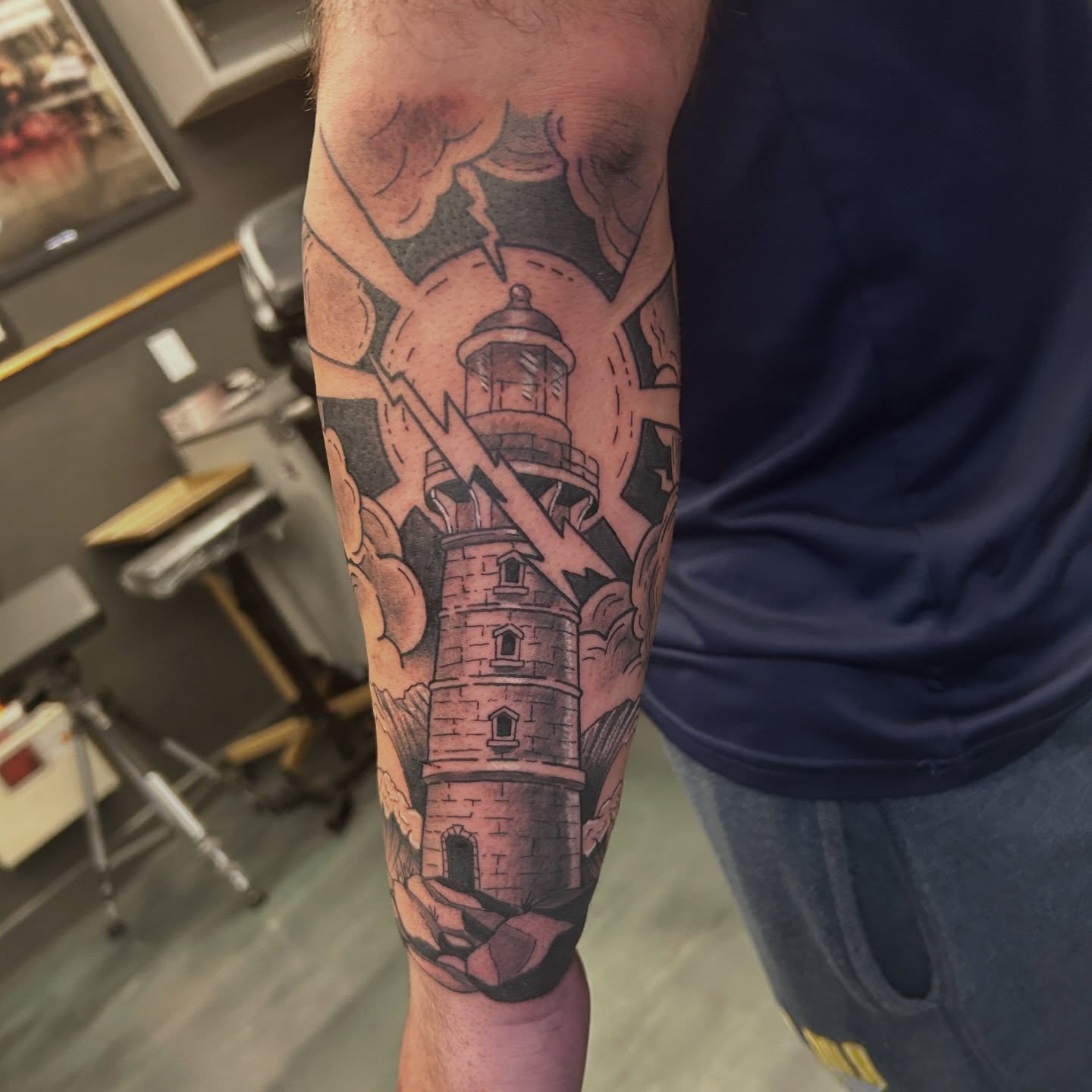 Lighthouse American traditional tattoo on the forearm by Mickey