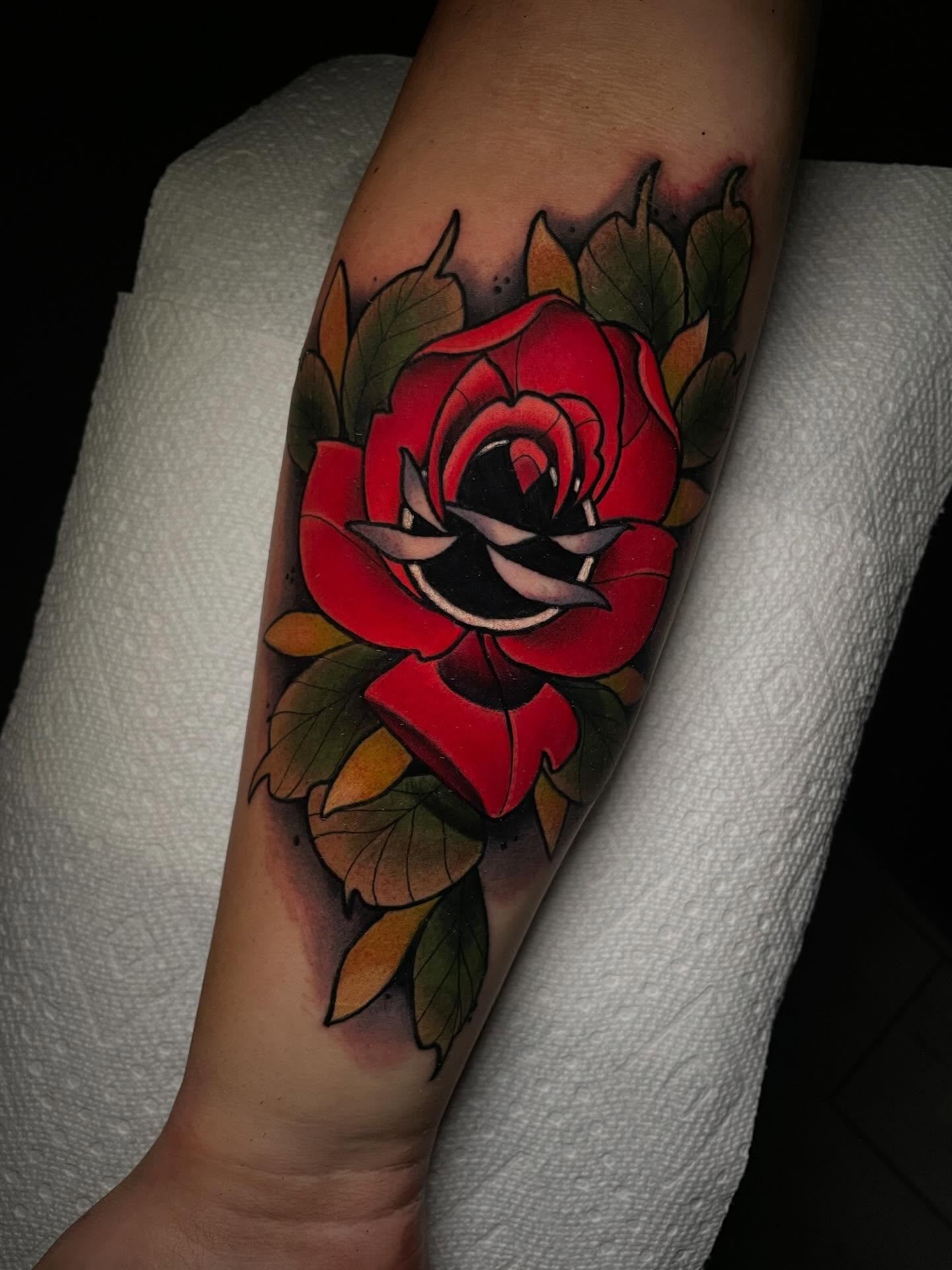 Red rose American traditional tattoo on the forearm by Kenneth Ruiz