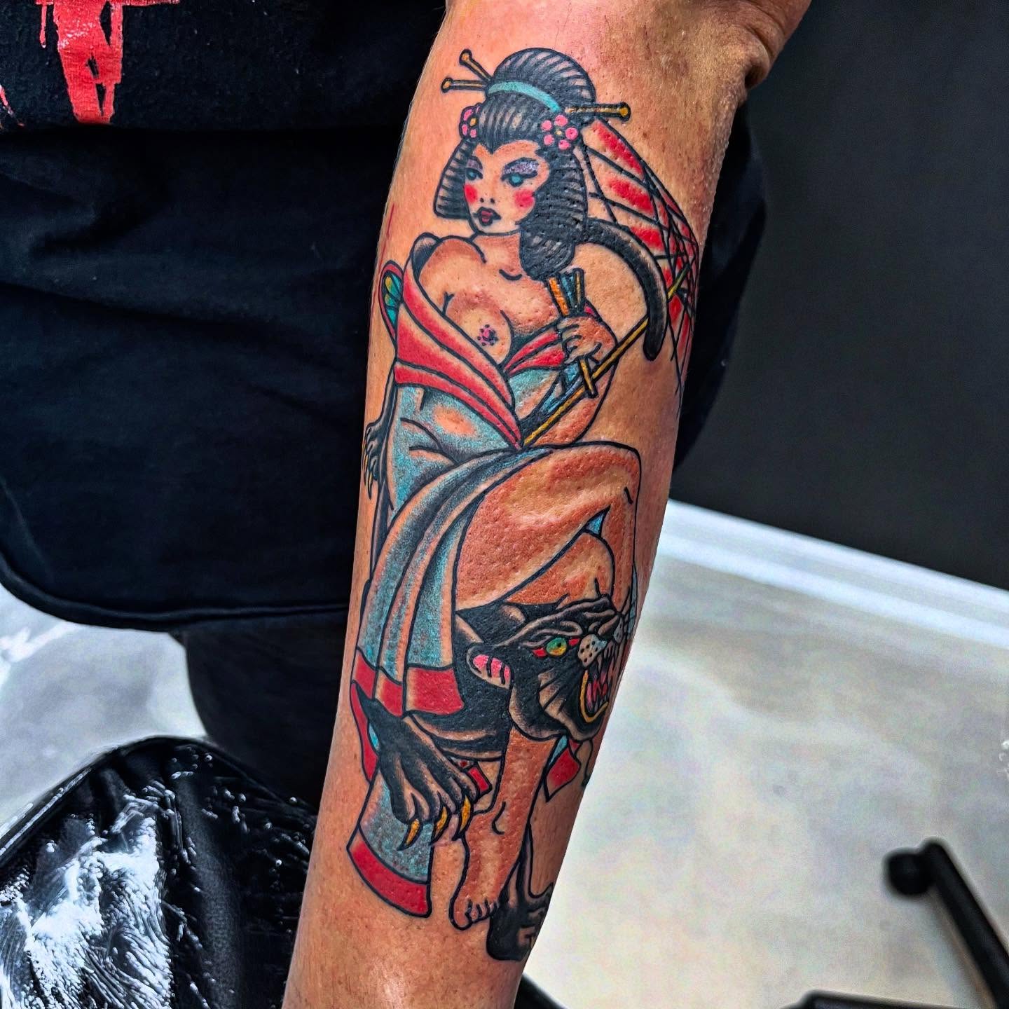 Geisha with panther American traditional tattoo on the forearm by Tyler Howard