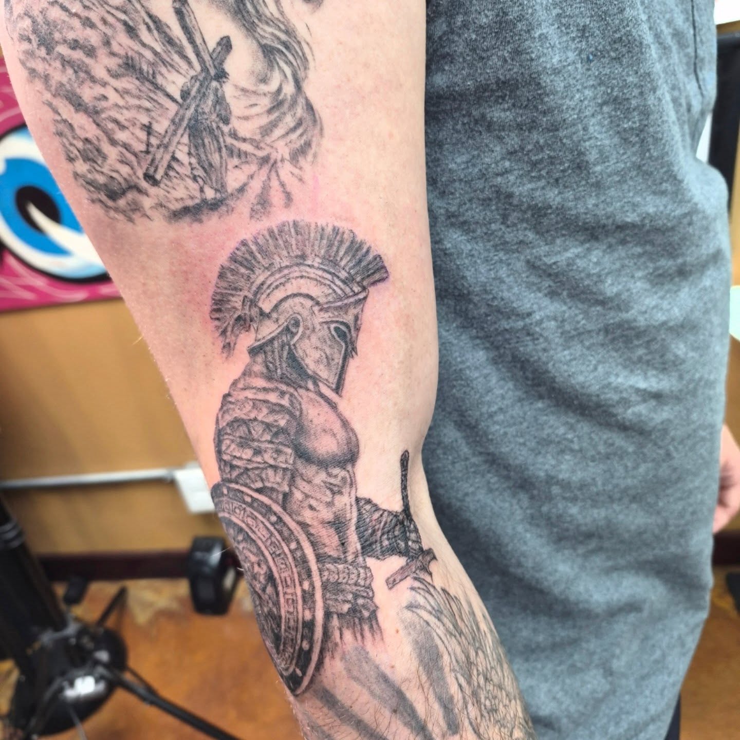 Spartan warrior black and grey tattoo on the forearm by Chris Bell
