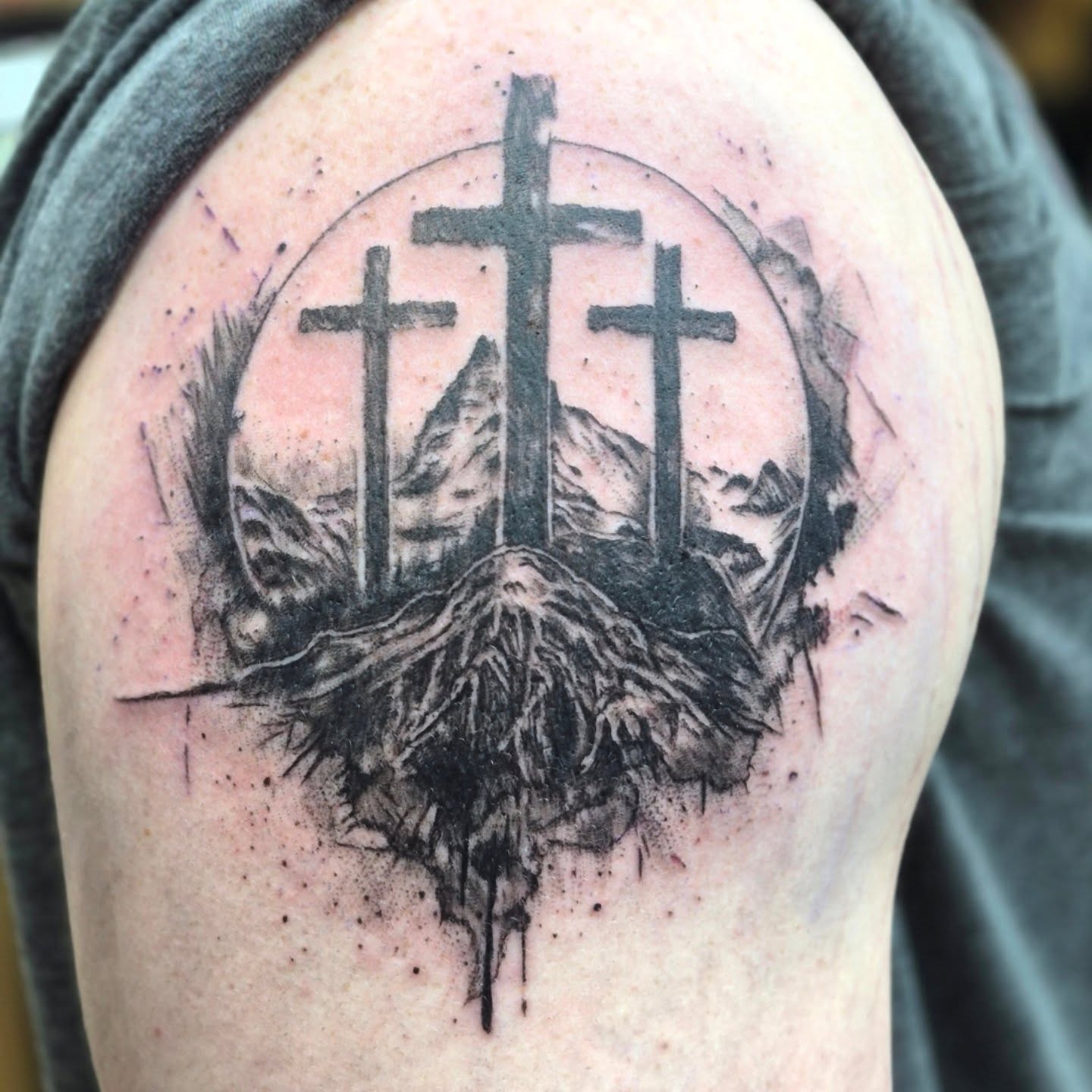 Three crosses dotwork tattoo on the shoulder by Chris Bell