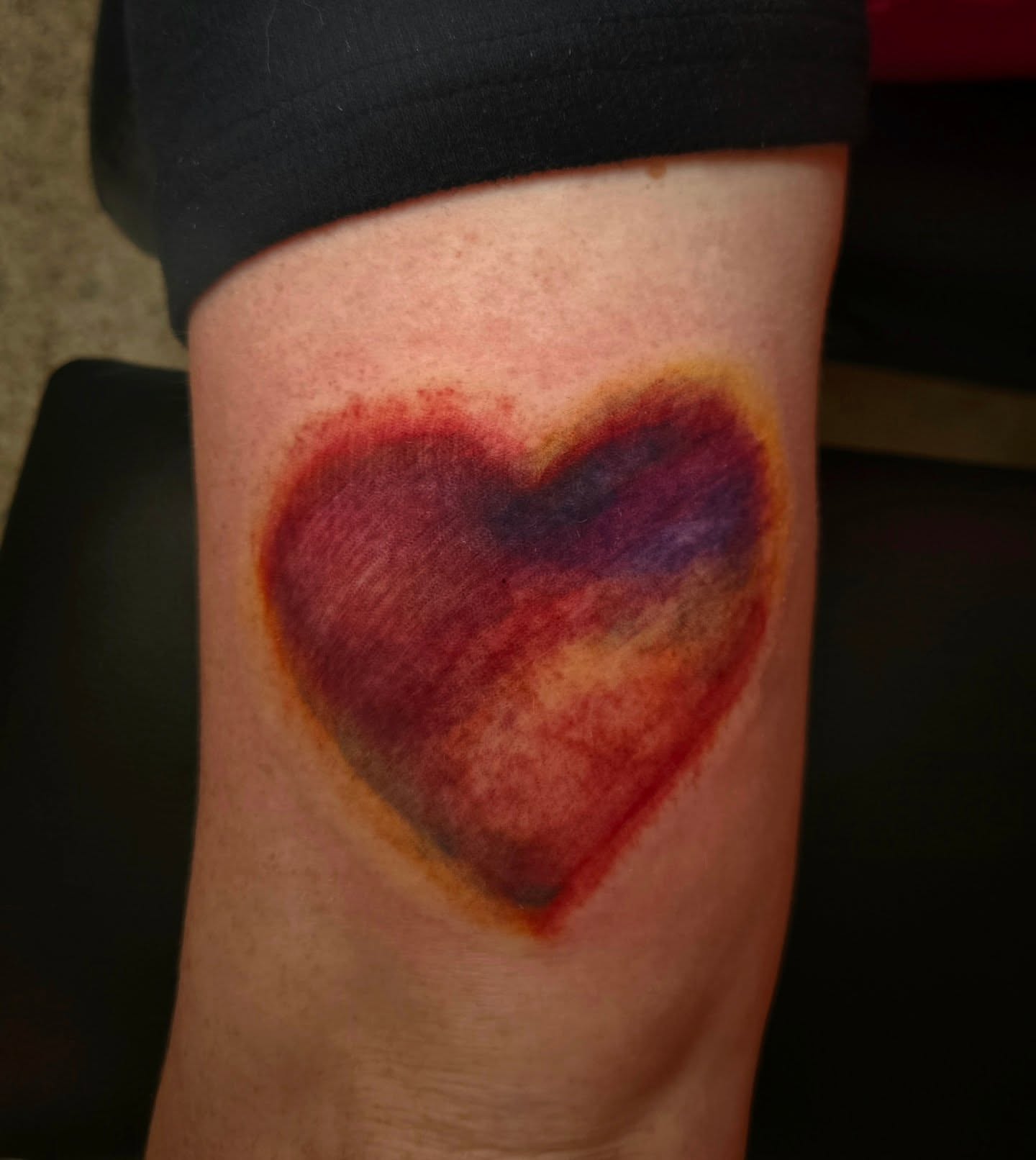 Heart watercolor tattoo on the forearm by Lane