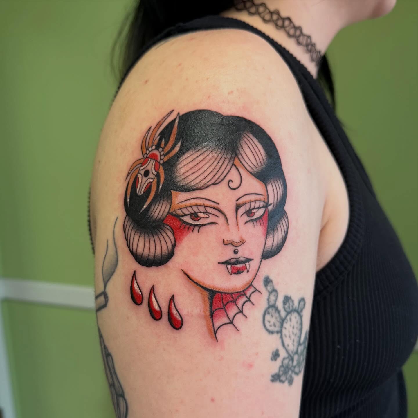 Woman with snake American traditional tattoo on the shoulder by charlie