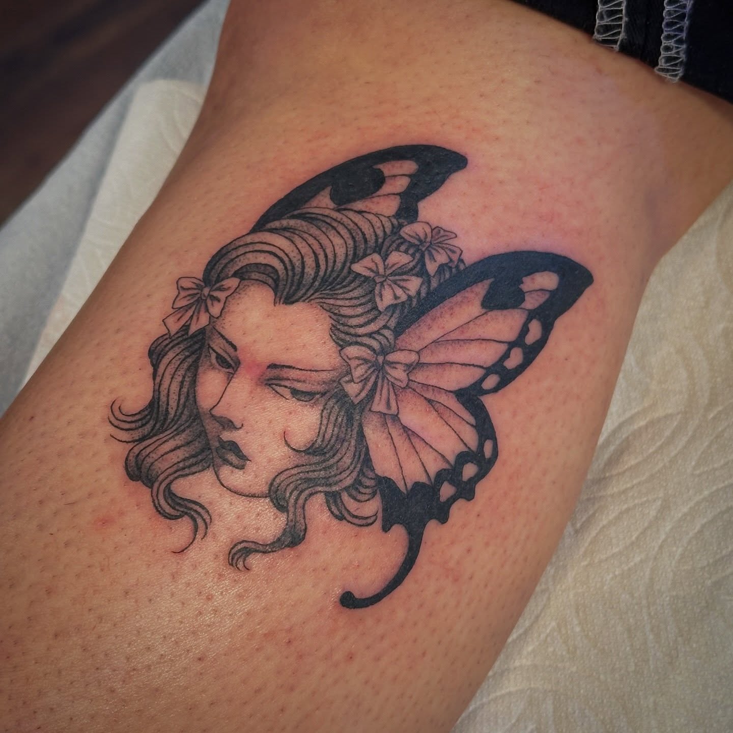 Woman with butterfly wings realism tattoo on the thigh by Bree Lin
