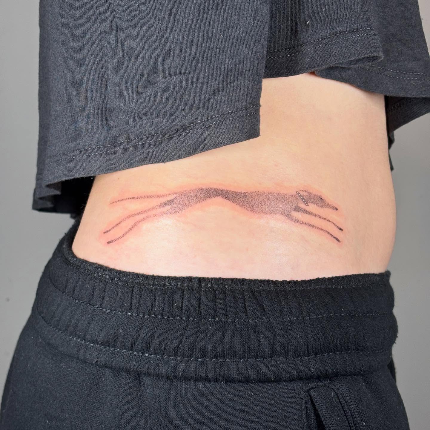 Hand dotwork tattoo on the torso by Jill