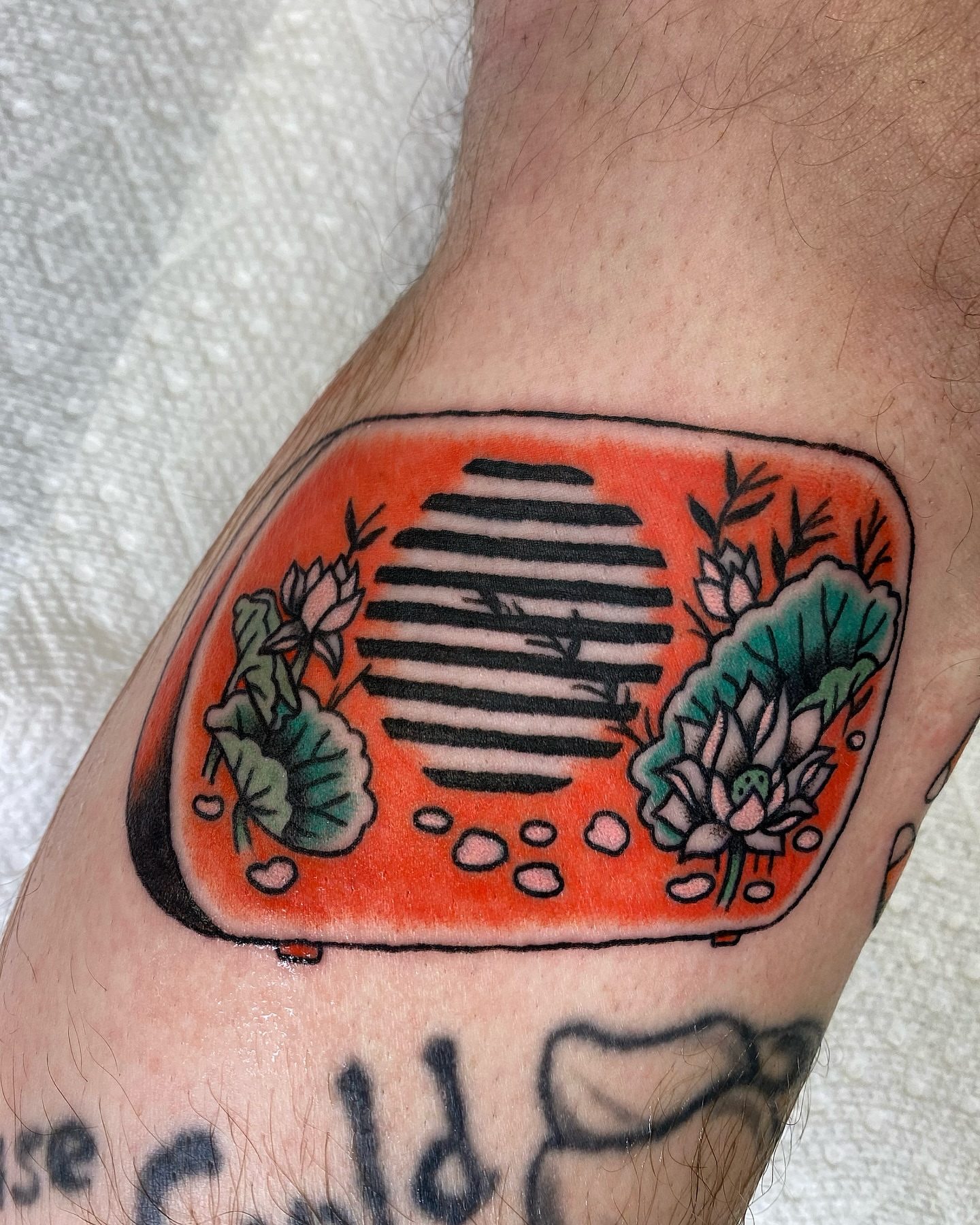 Radio with floral decorations American traditional tattoo on the forearm by Corinne Carter