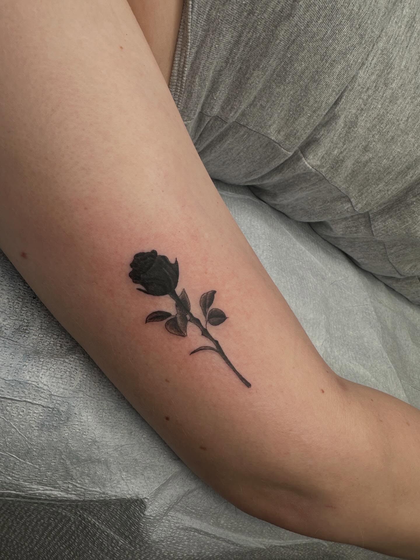 Rose black and grey tattoo on the forearm by Alex Gunshefski