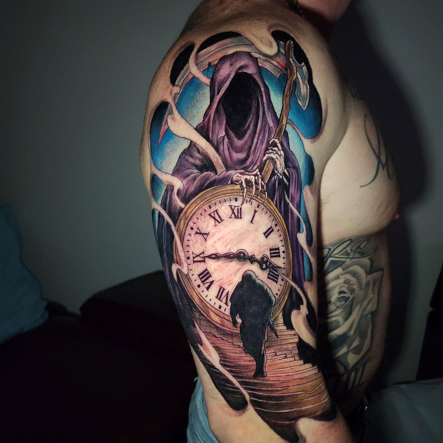 Grim reaper dark realism tattoo on the upper arm by Chris Bowen